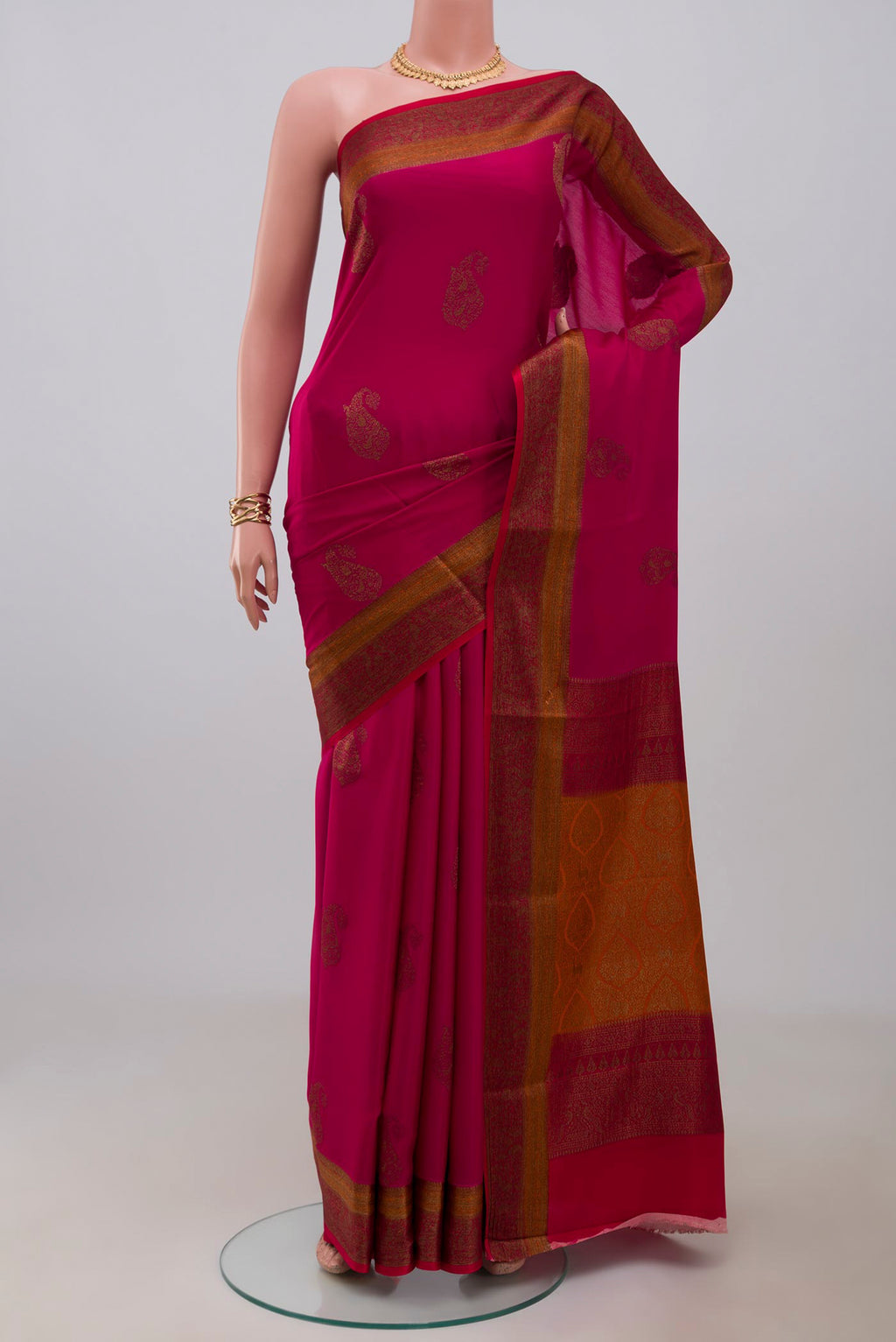 Pink Crepe Saree with Zari Butta on the body and Fancy Border.  displayed on a mannequin