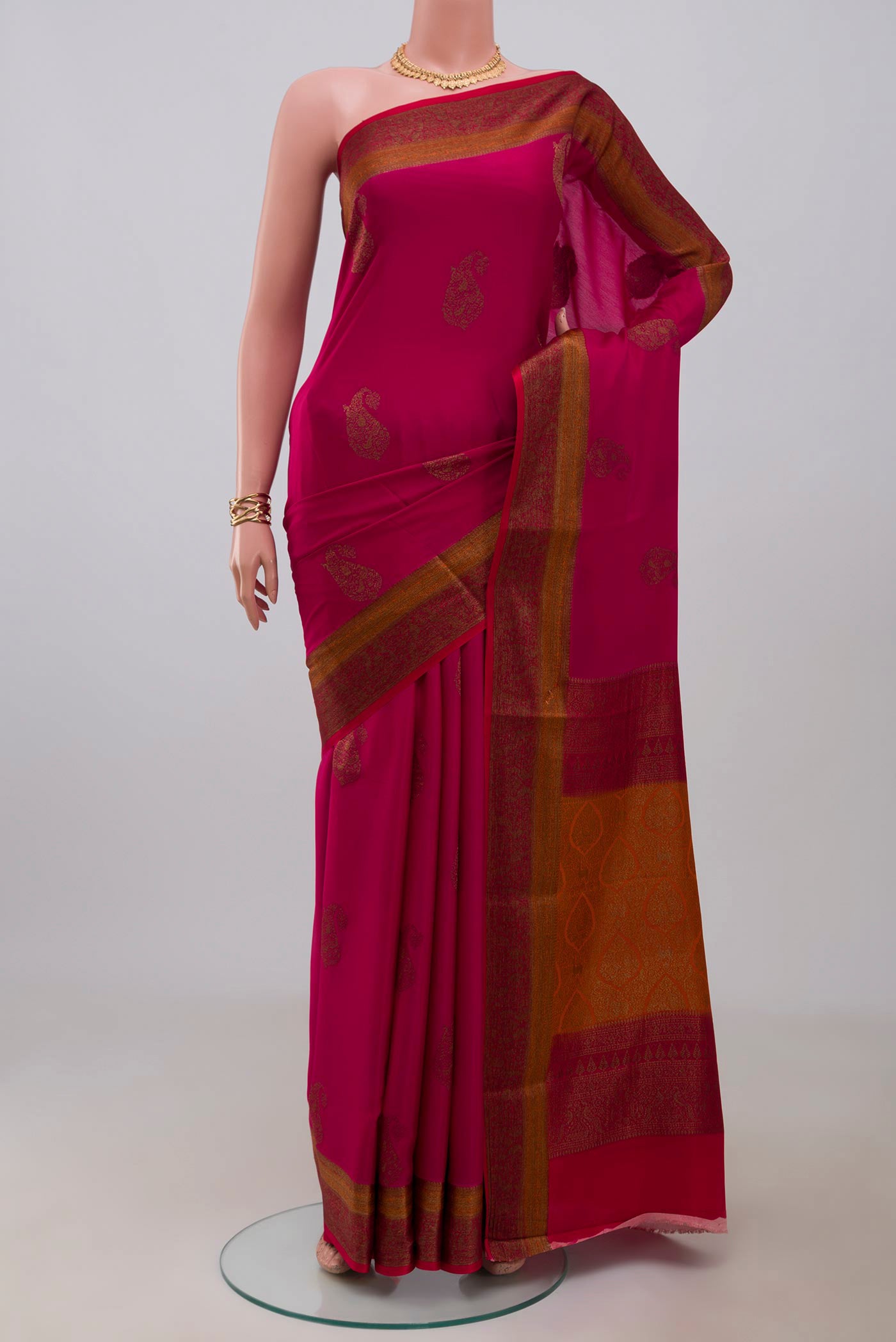 Pink Crepe Saree with Zari Butta on the body and Fancy Border.  displayed on a mannequin