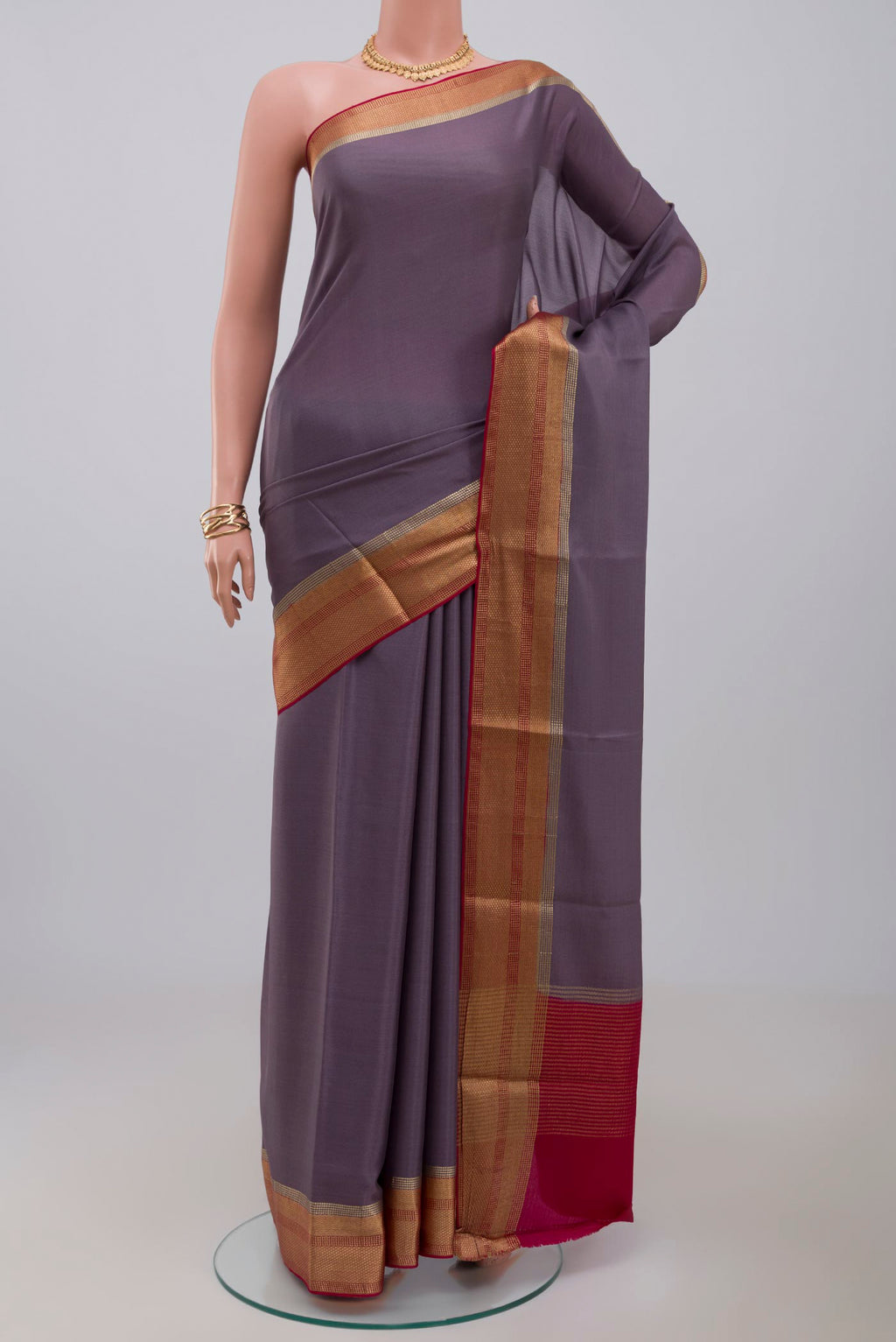 Lavender Crepe Saree with Plain Body and Zari Border.  displayed on a mannequin