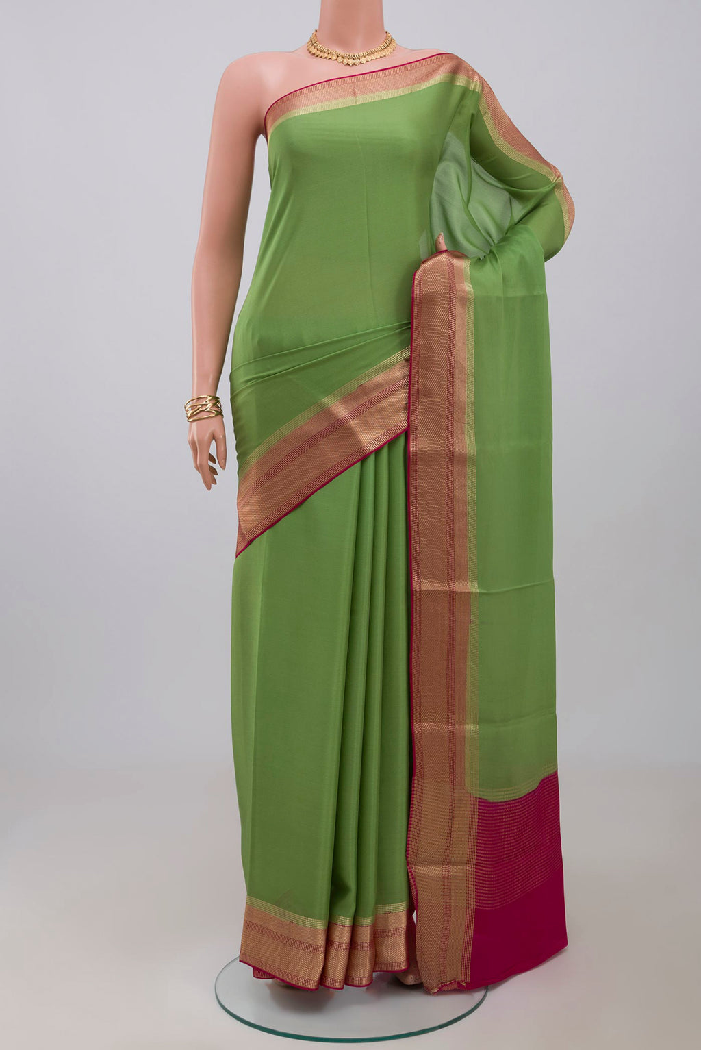 Parrot Green Mysore Crepe Saree with Plain Body and Zari Border.  displayed on a mannequin