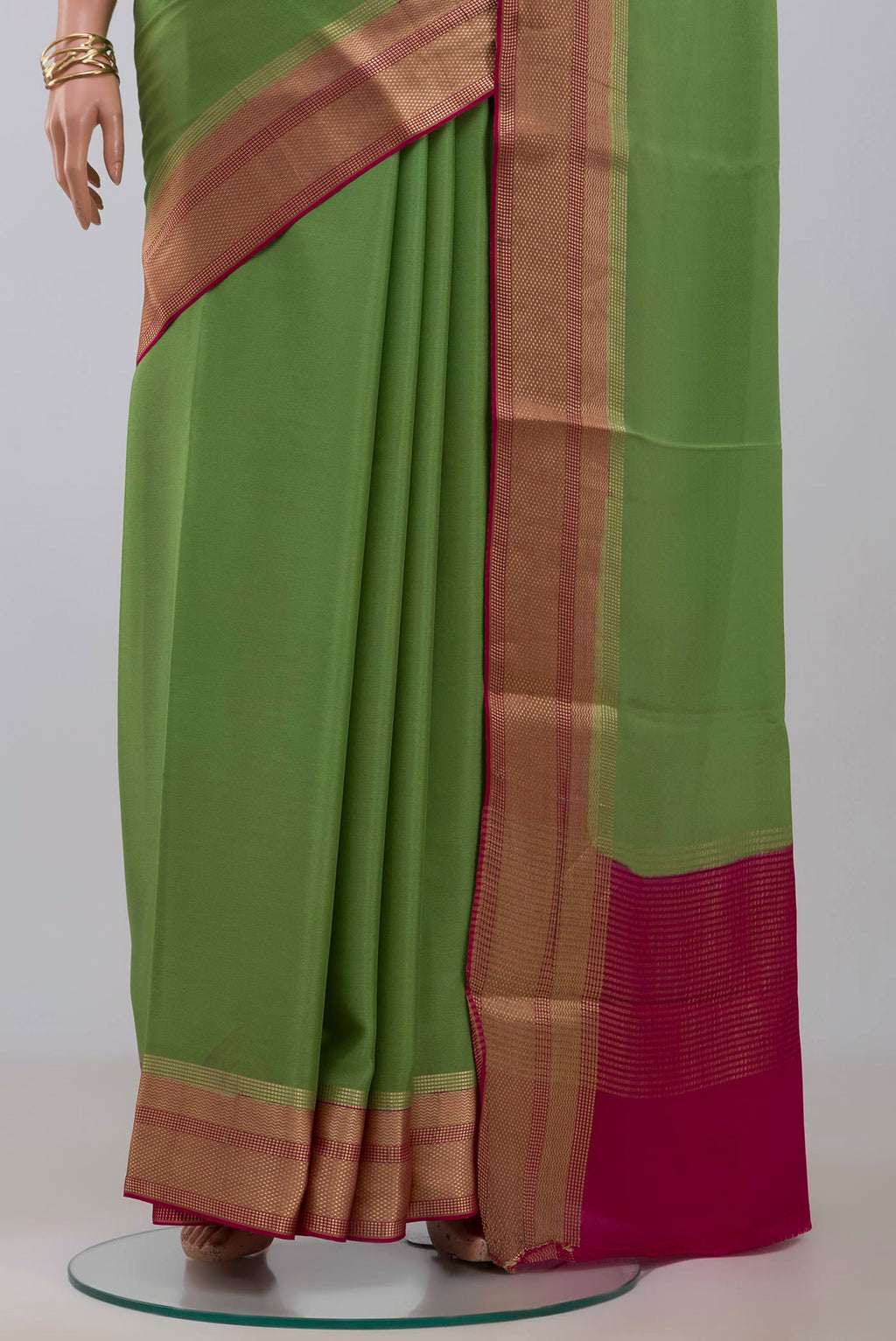Pleats and pallu of Parrot Green Mysore Crepe Saree with Plain Body and Zari Border. 