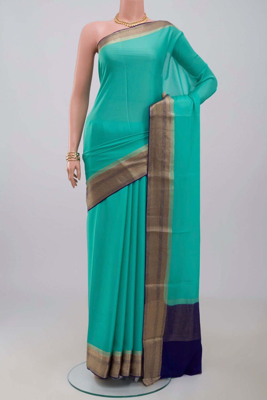 Sky Blue Crepe Saree with Plain Body and Zari Border.  displayed on a mannequin