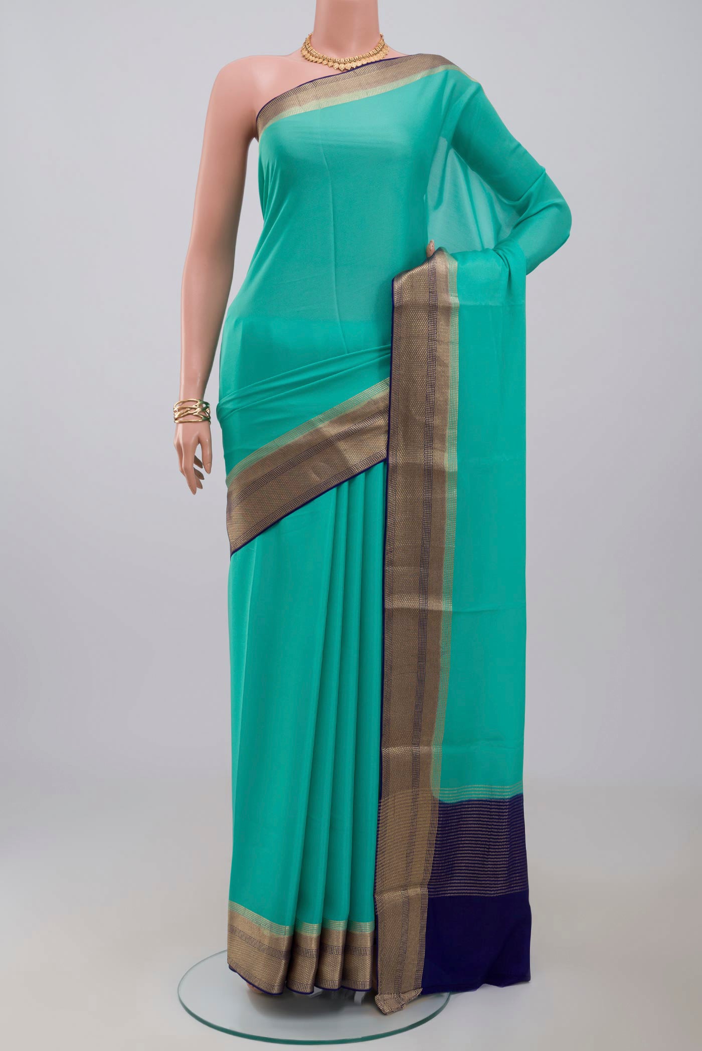 Sky Blue Crepe Saree with Plain Body and Zari Border.  displayed on a mannequin