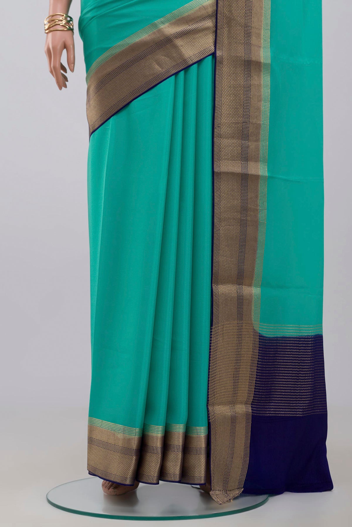 Pleats and pallu of Sky Blue Crepe Saree with Plain Body and Zari Border. 