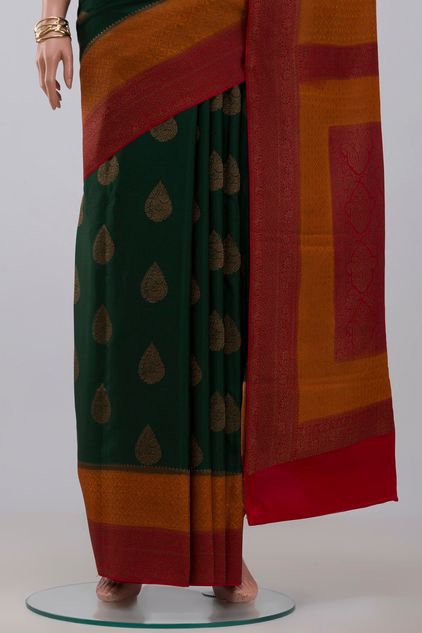 Pleats and pallu of Green Crepe Saree with Zari Butta on the body and Zari Border. 
