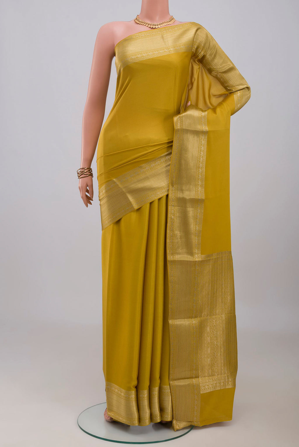 Yellow Mysore Crepe Saree with Plain Body and Zari Border.  displayed on a mannequin