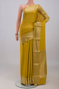 Yellow Mysore Crepe Saree with Plain Body and Zari Border.  displayed on a mannequin