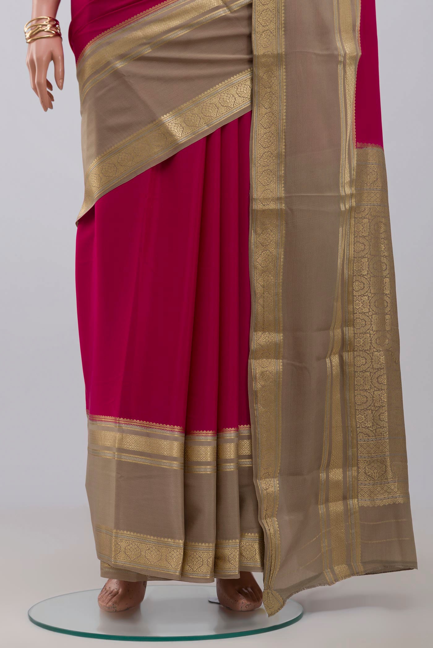 Pleats and pallu of Pink Crepe Saree with Plain Body and Zari Border. 