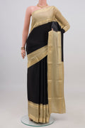 Black Mysore Crepe Saree with Plain Body and Zari Border.  displayed on a mannequin