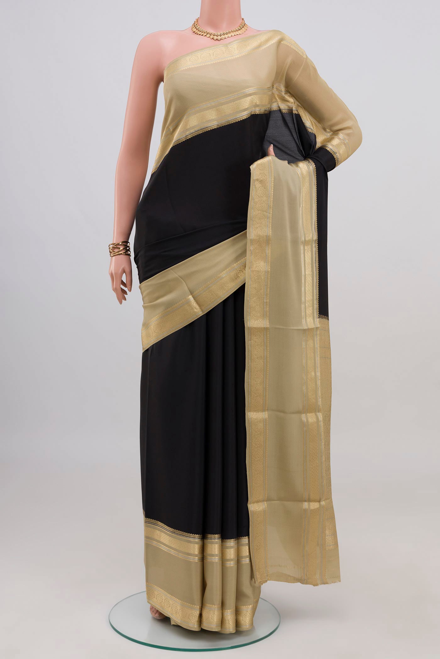 Black Mysore Crepe Saree with Plain Body and Zari Border.  displayed on a mannequin