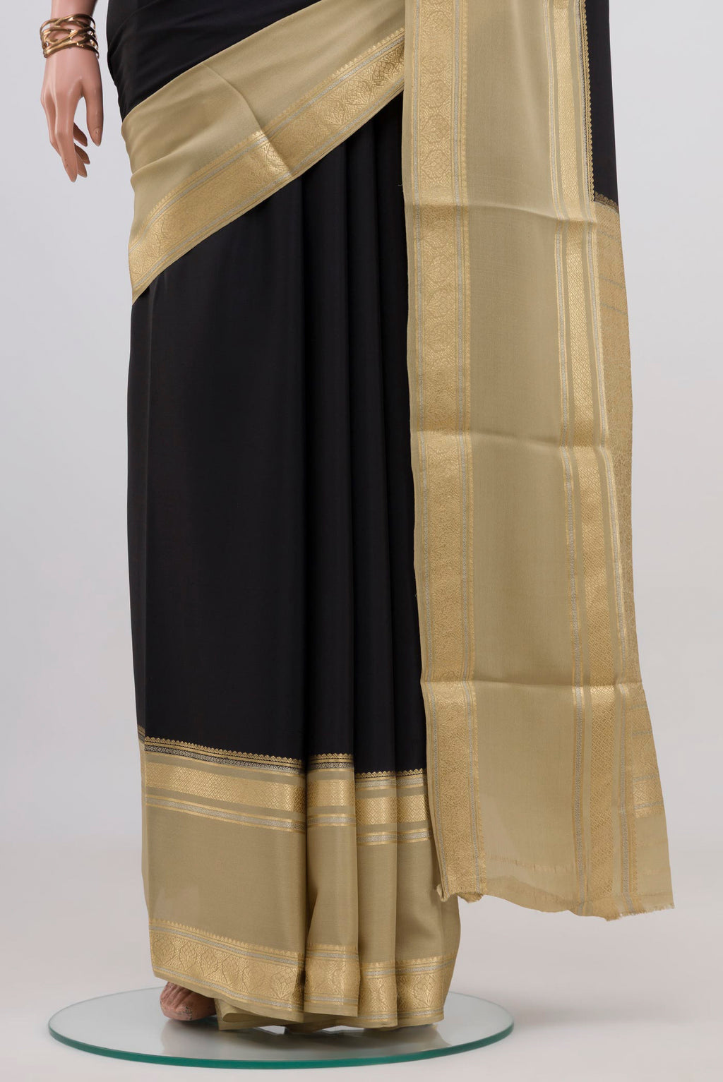 Pleats and pallu of Black Mysore Crepe Saree with Plain Body and Zari Border. 