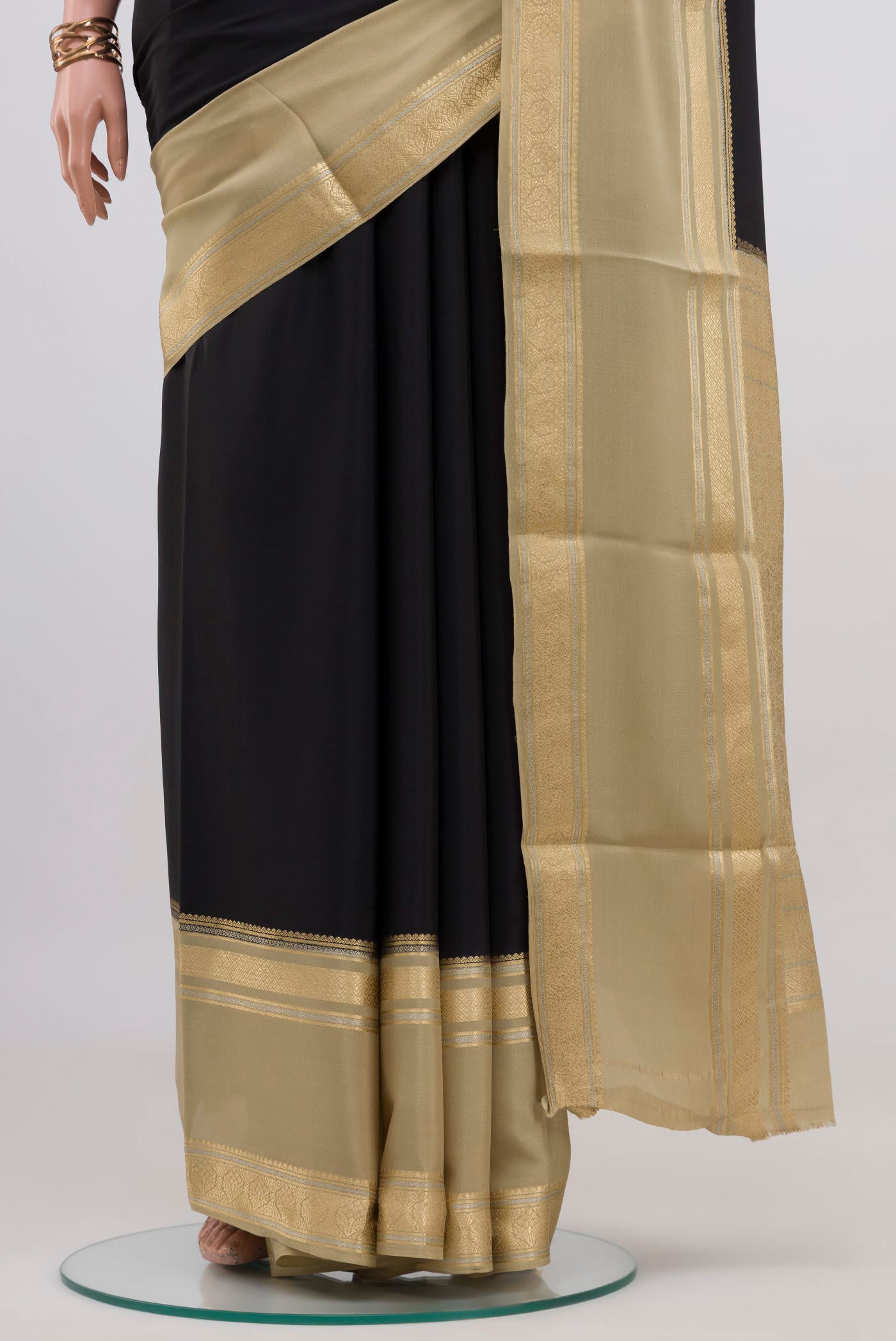 Pleats and pallu of Black Mysore Crepe Saree with Plain Body and Zari Border. 