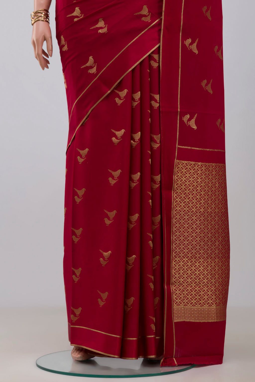 Pleats and pallu of Red Crepe Saree with Zari Butta on the body and Thin Zari Line. 