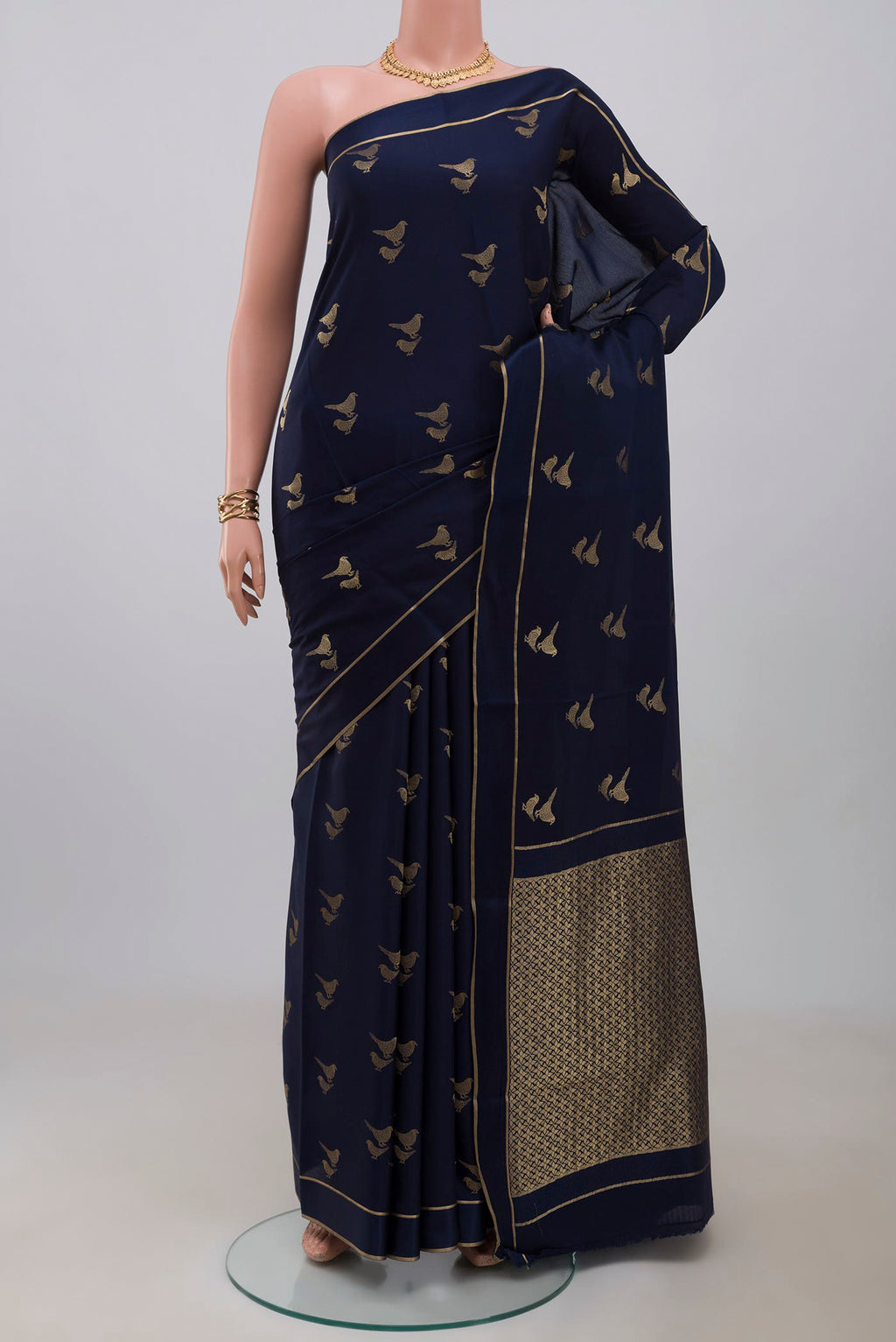 Blue Crepe Saree with Zari Butta on the body and Thin Zari Line.  displayed on a mannequin