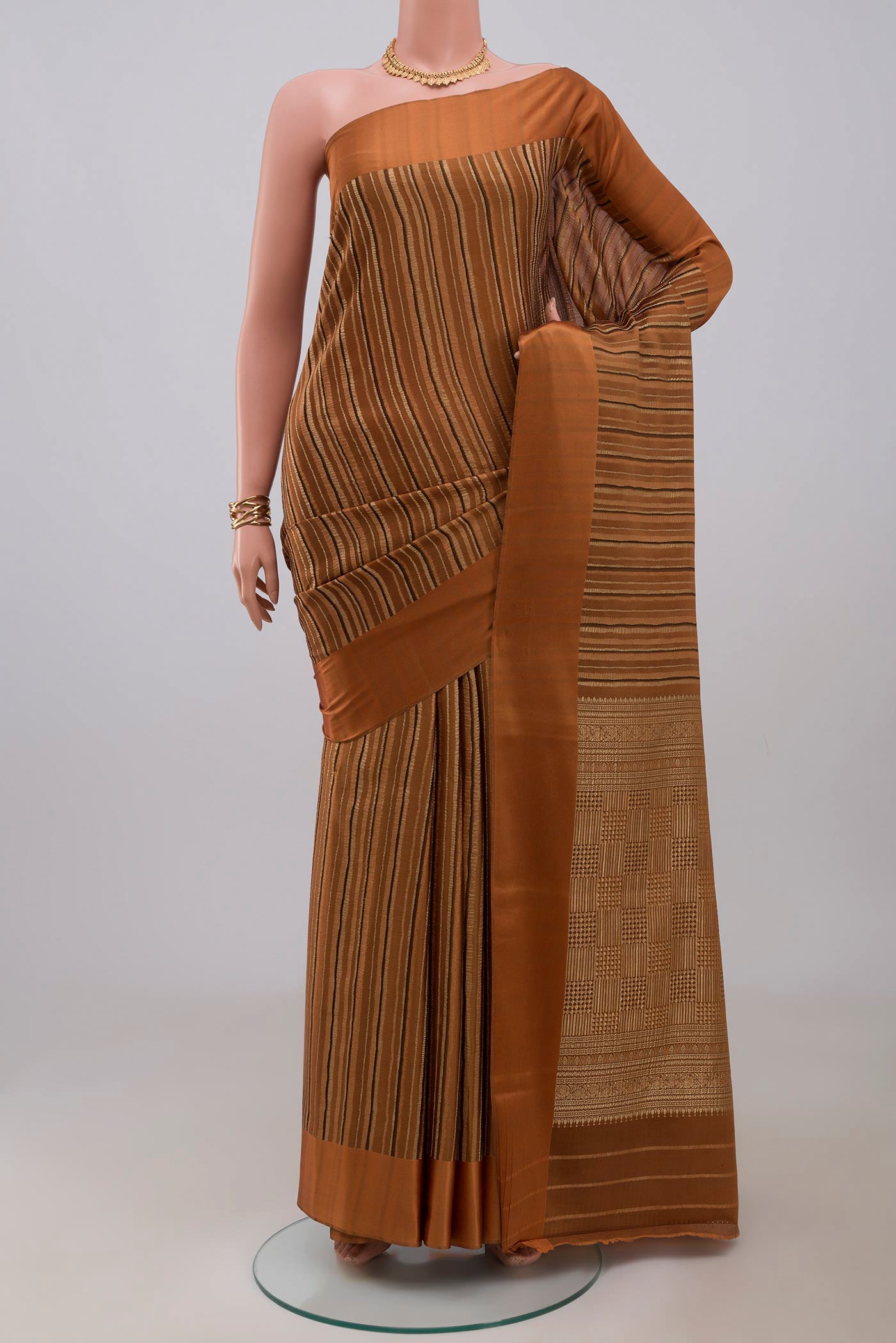 Rust Mysore Crepe Saree with Stripes on the body and Plain Border.  displayed on a mannequin