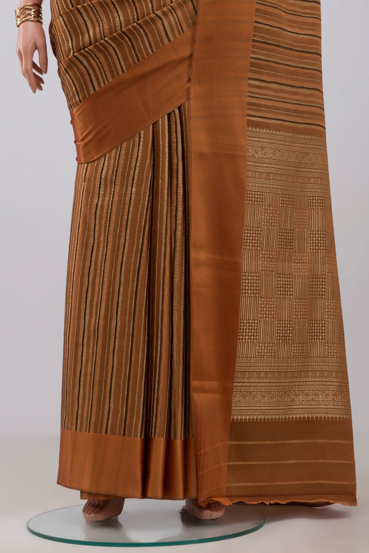Pleats and pallu of Rust Mysore Crepe Saree with Stripes on the body and Plain Border. 
