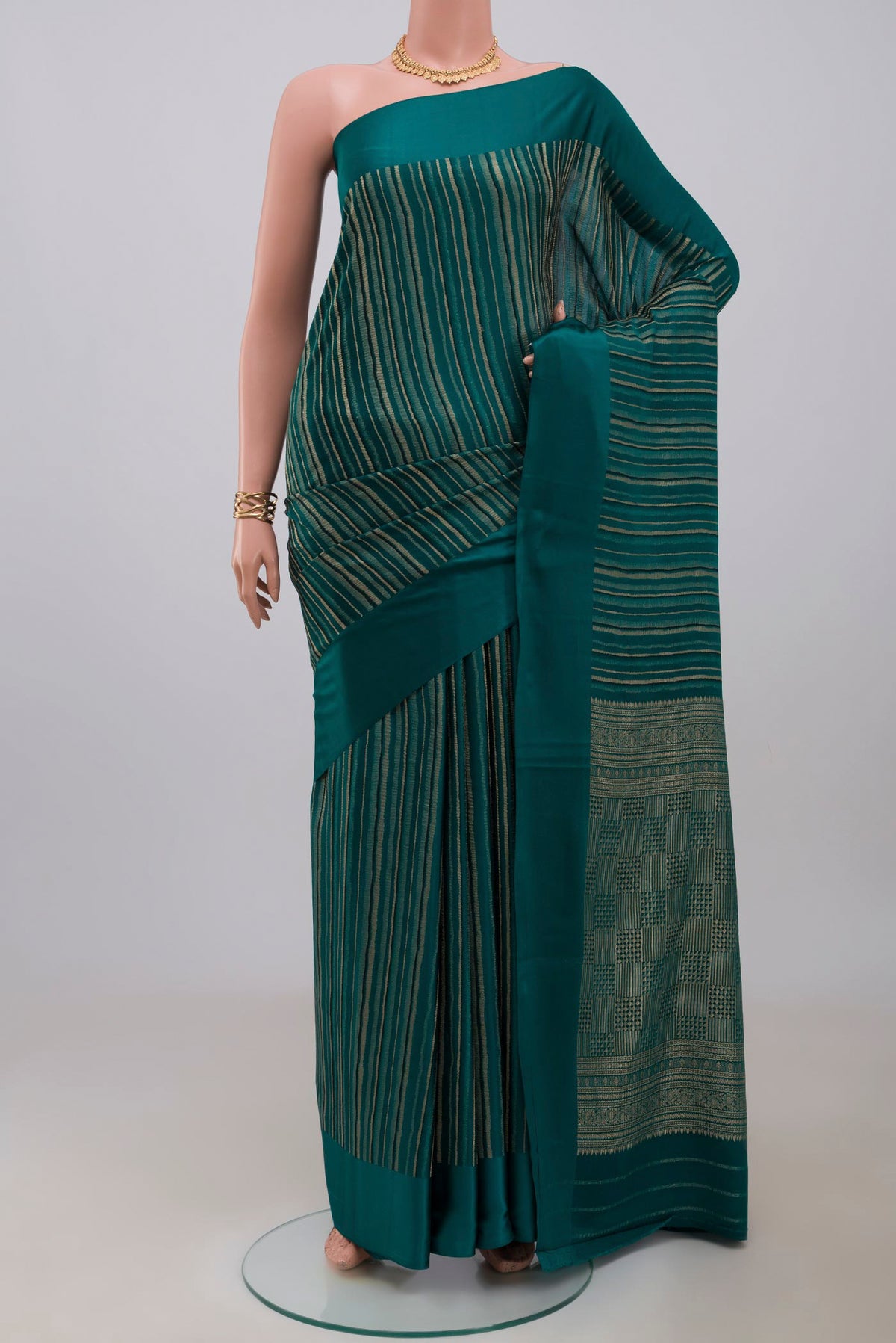 Green Mysore Crepe Saree with Stripes on the body and Plain Border.  displayed on a mannequin