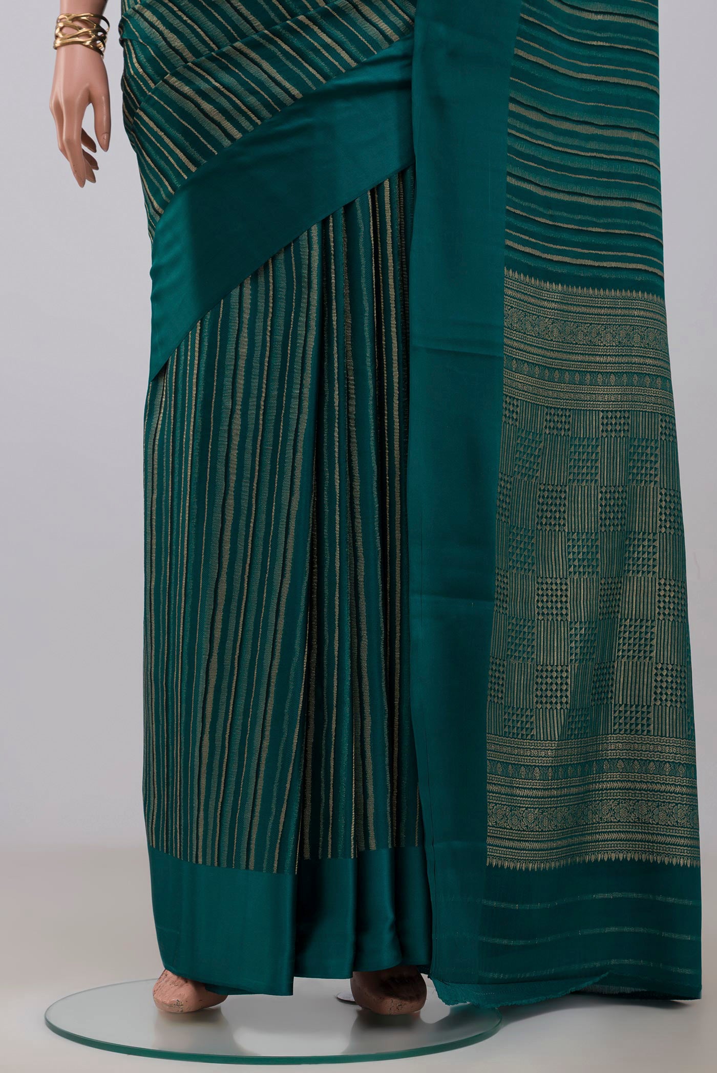 Pleats and pallu of Green Mysore Crepe Saree with Stripes on the body and Plain Border. 