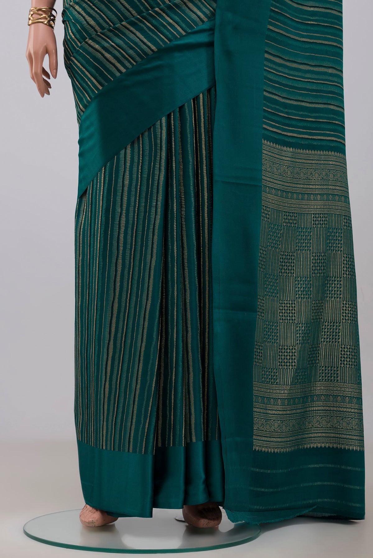 Pleats and pallu of Green Mysore Crepe Saree with Stripes on the body and Plain Border. 
