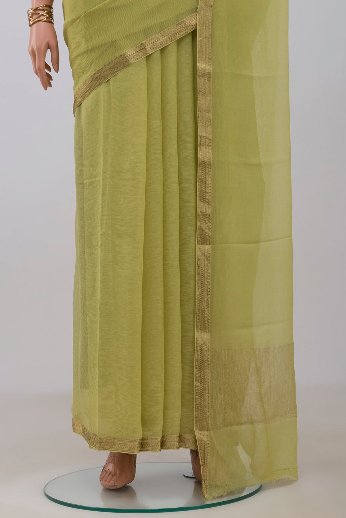 Pleats and pallu of Light Green Mysore Chiffon Saree with Plain Body and Zari Border. 