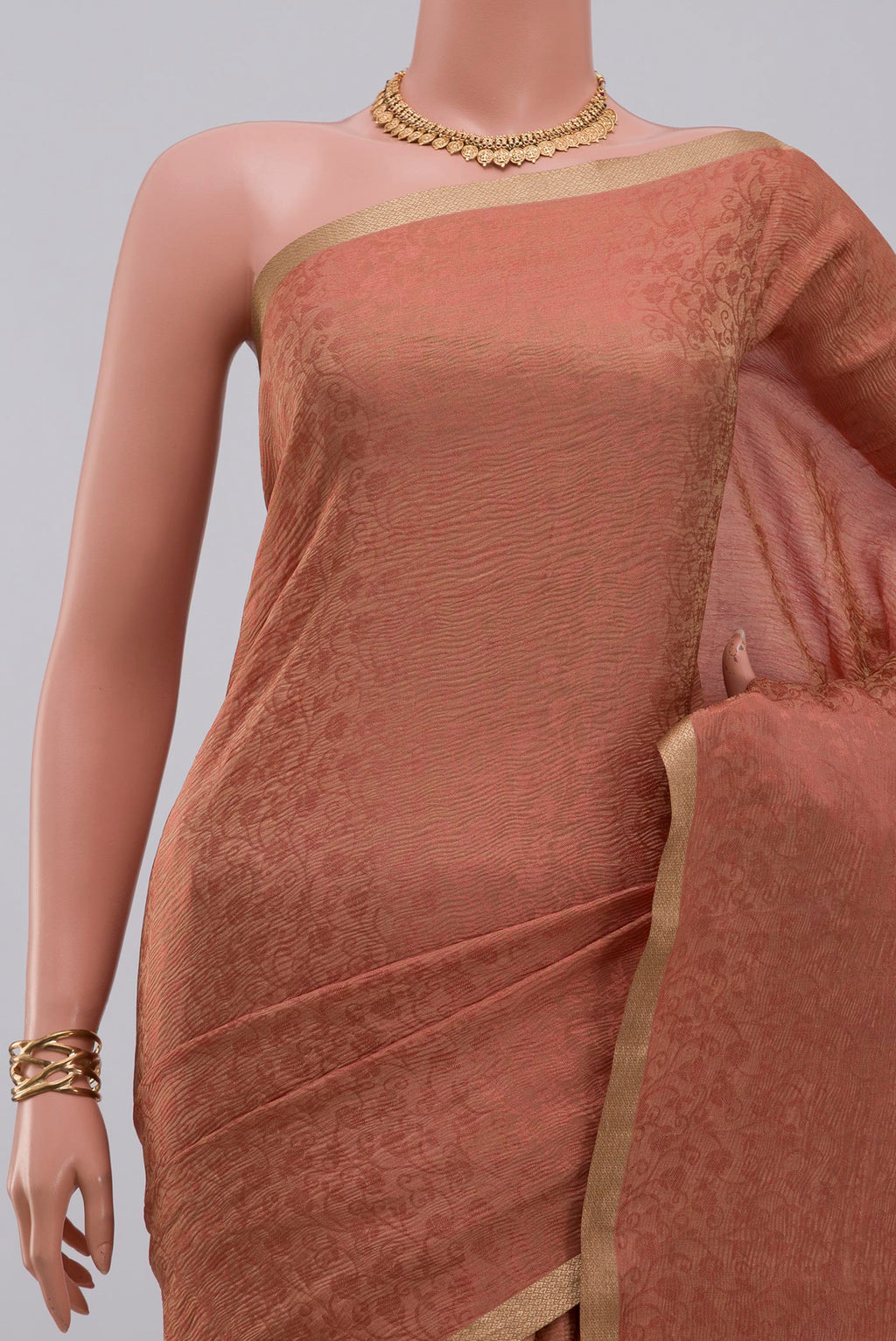 Border image of Peach Crepe Saree with Fancy on the body and Zari Border. 