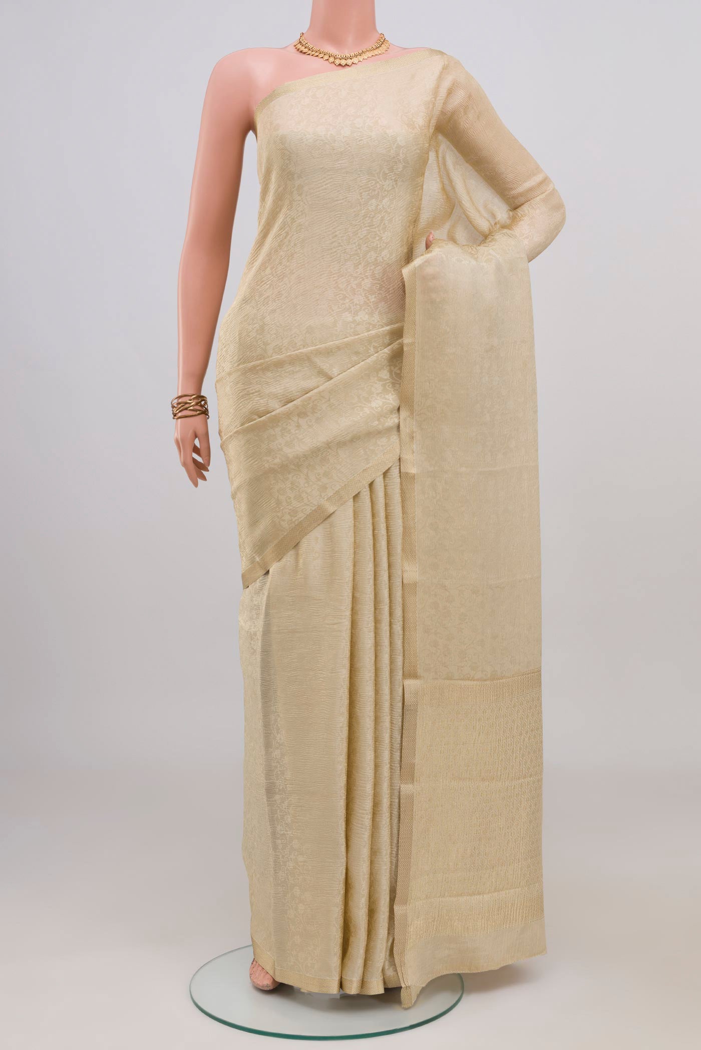 Cream Mysore Crepe Saree with Zari Brocade on the body and Thin Zari Line.  displayed on a mannequin