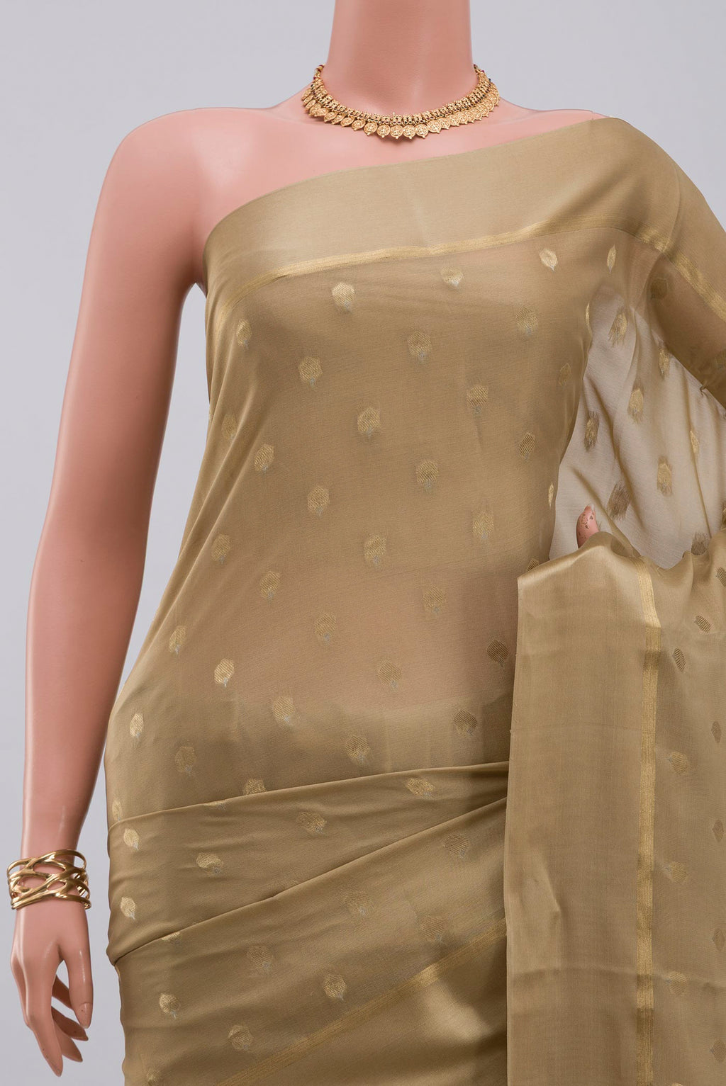 Border image of Beige Crepe Saree with Zari Butta on the body and Thin Zari Line. 