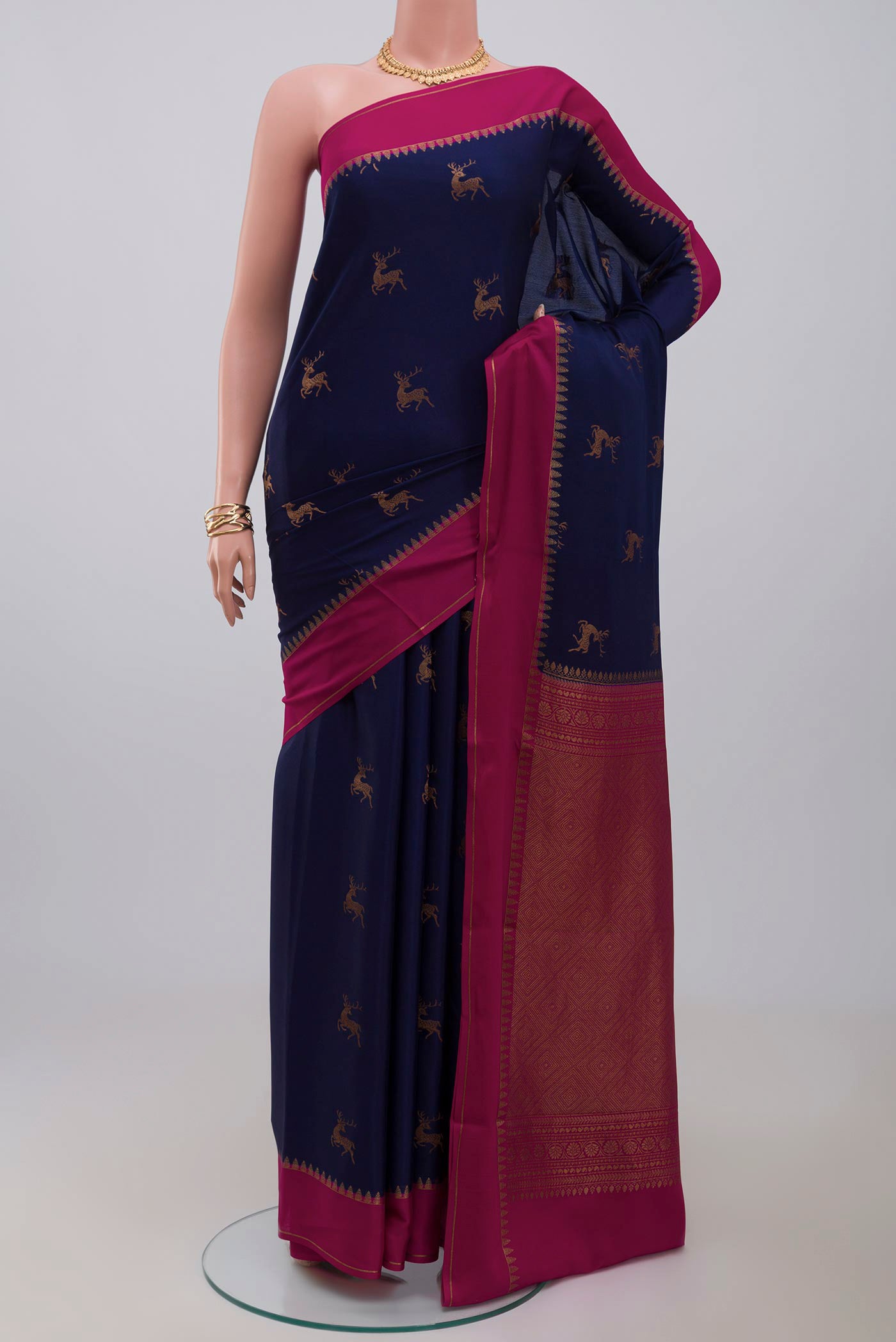 Navy Blue Crepe Saree with Zari Butta on the body and Thin Zari Line.  displayed on a mannequin