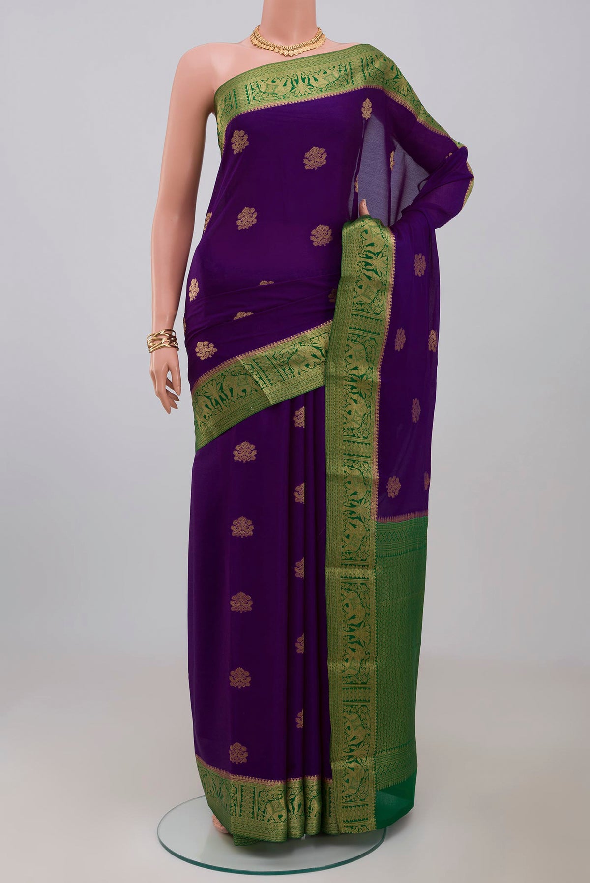 Purple Crepe Saree with Zari Butta on the body and Zari Border.  displayed on a mannequin