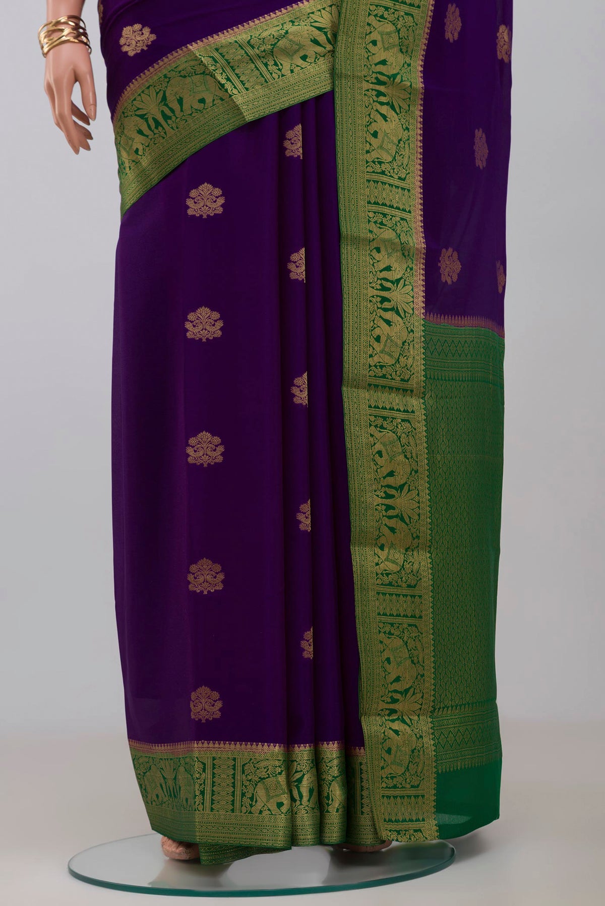 Pleats and pallu of Purple Crepe Saree with Zari Butta on the body and Zari Border. 