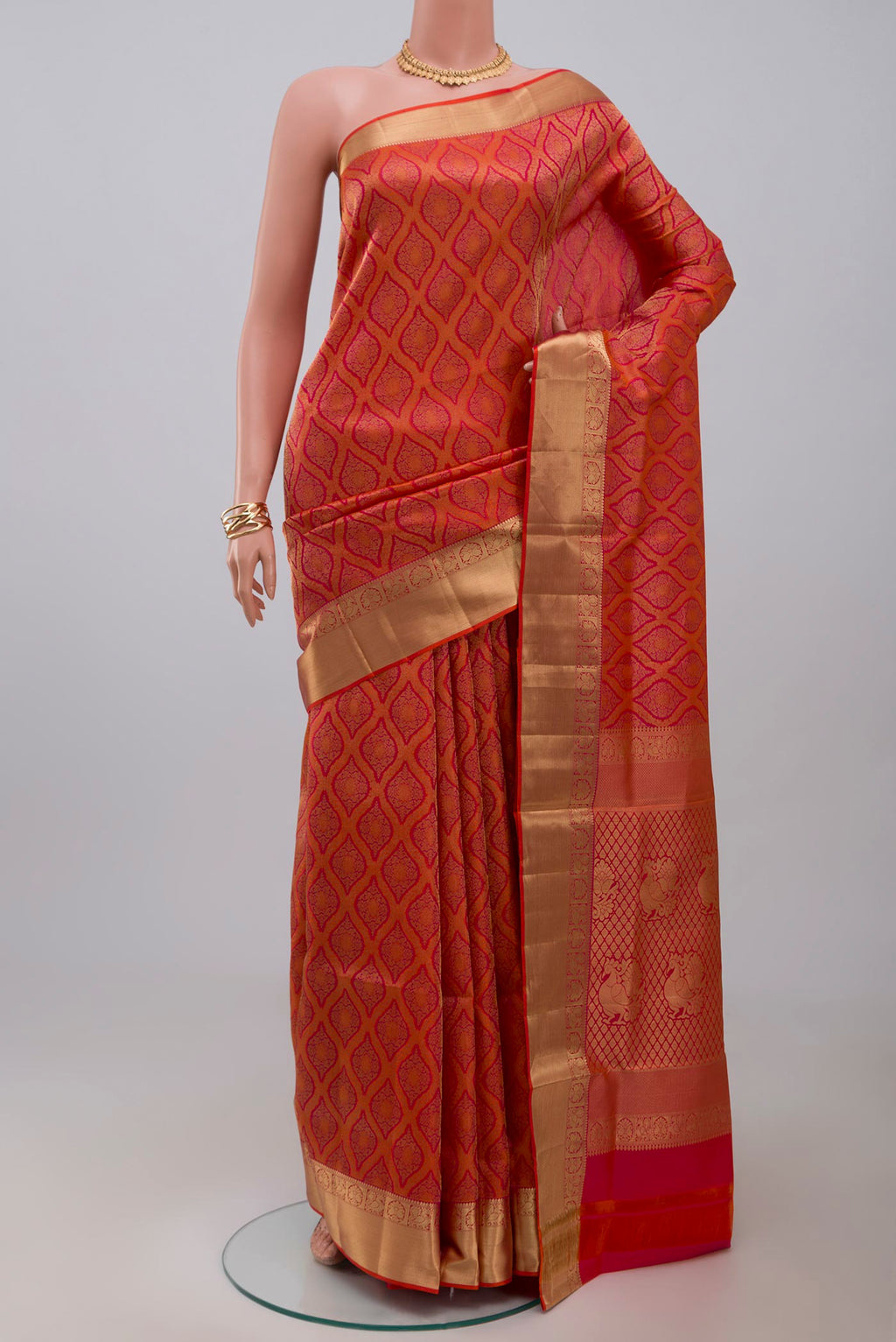 Orange Soft Silk Saree with Zari Brocade on the body and Zari Border.  displayed on a mannequin