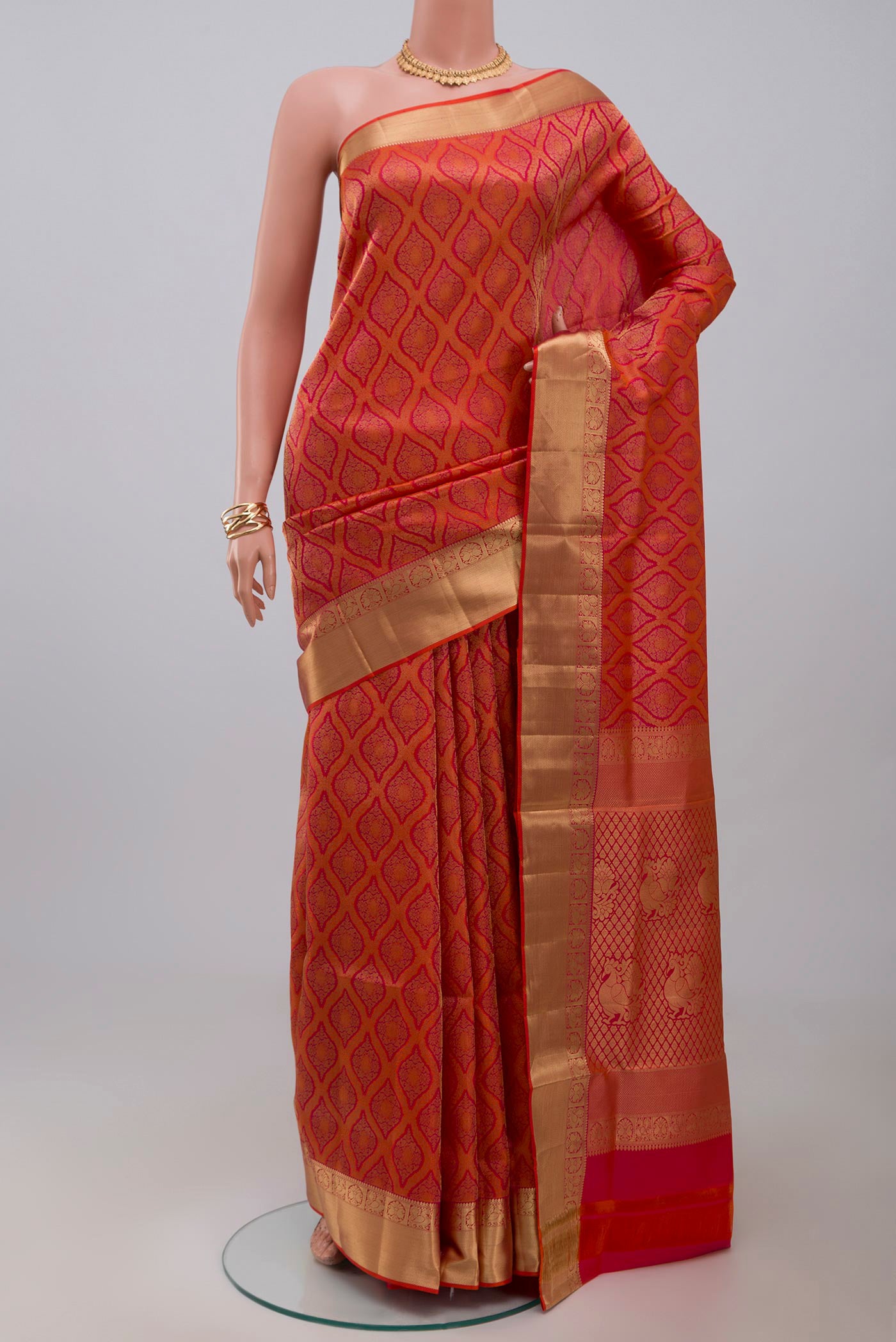 Orange Soft Silk Saree with Zari Brocade on the body and Zari Border.  displayed on a mannequin