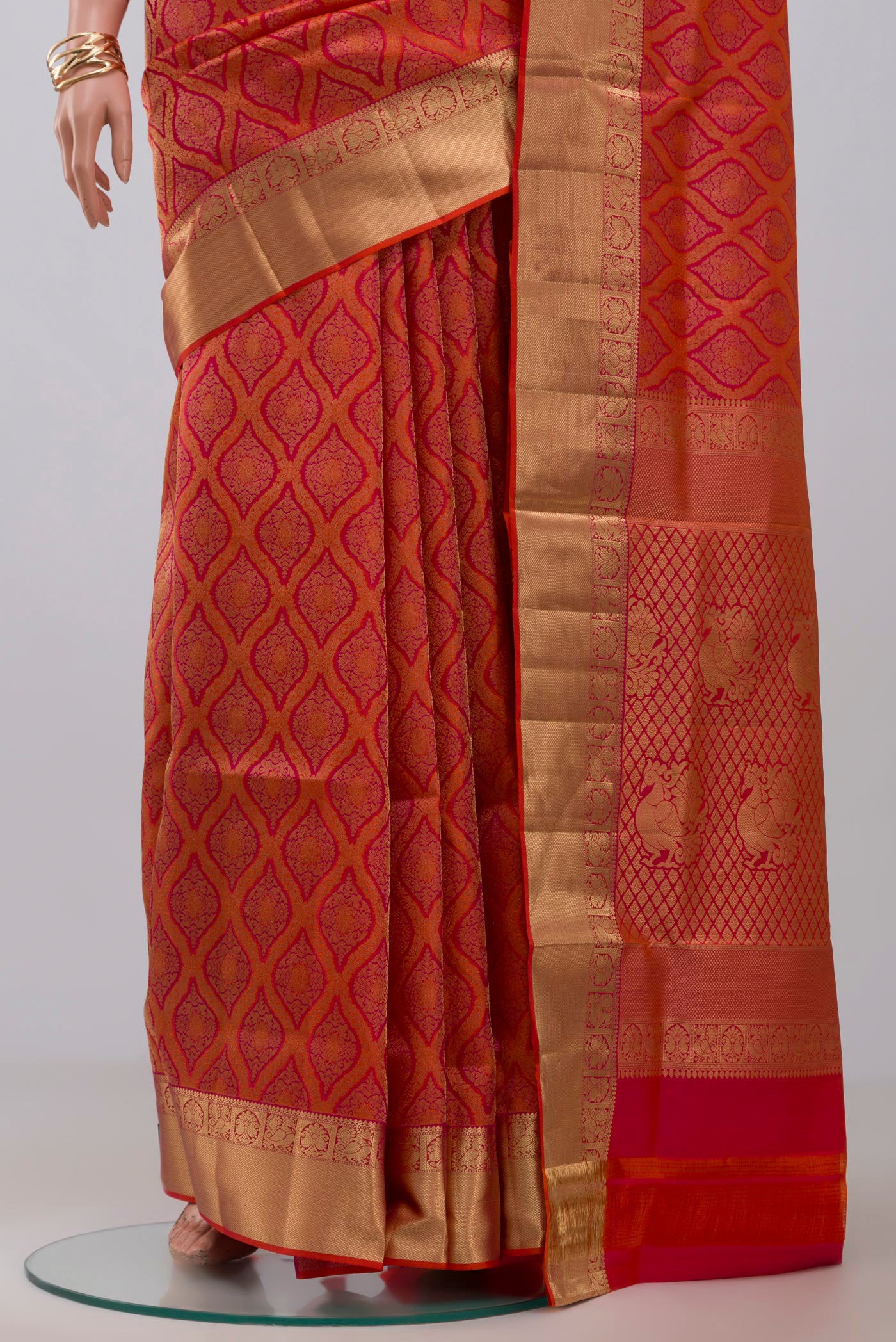 Pleats and pallu of Orange Soft Silk Saree with Zari Brocade on the body and Zari Border. 