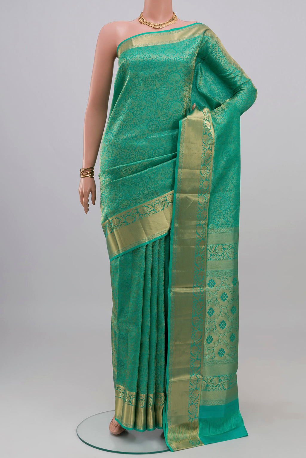 Turquoise Soft Silk Saree with Zari Brocade on the body and Zari Border.  displayed on a mannequin