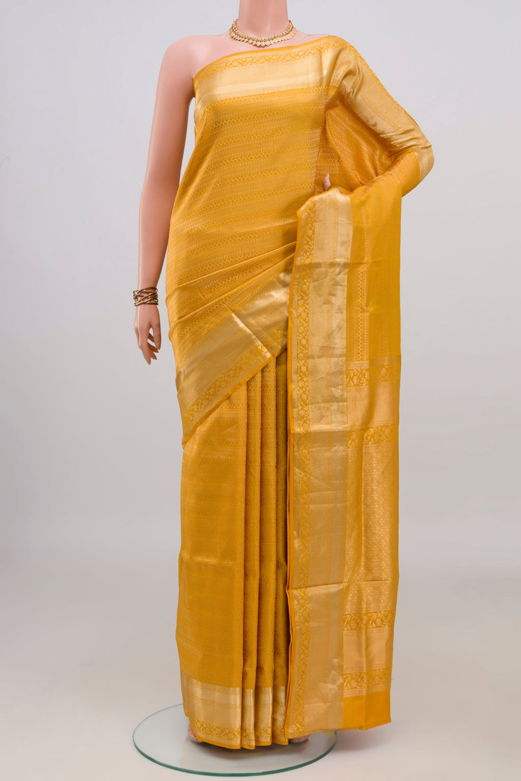 Pure Silk Yellow Soft Saree with Zari Brocade on the body and Zari Border.  displayed on a mannequin