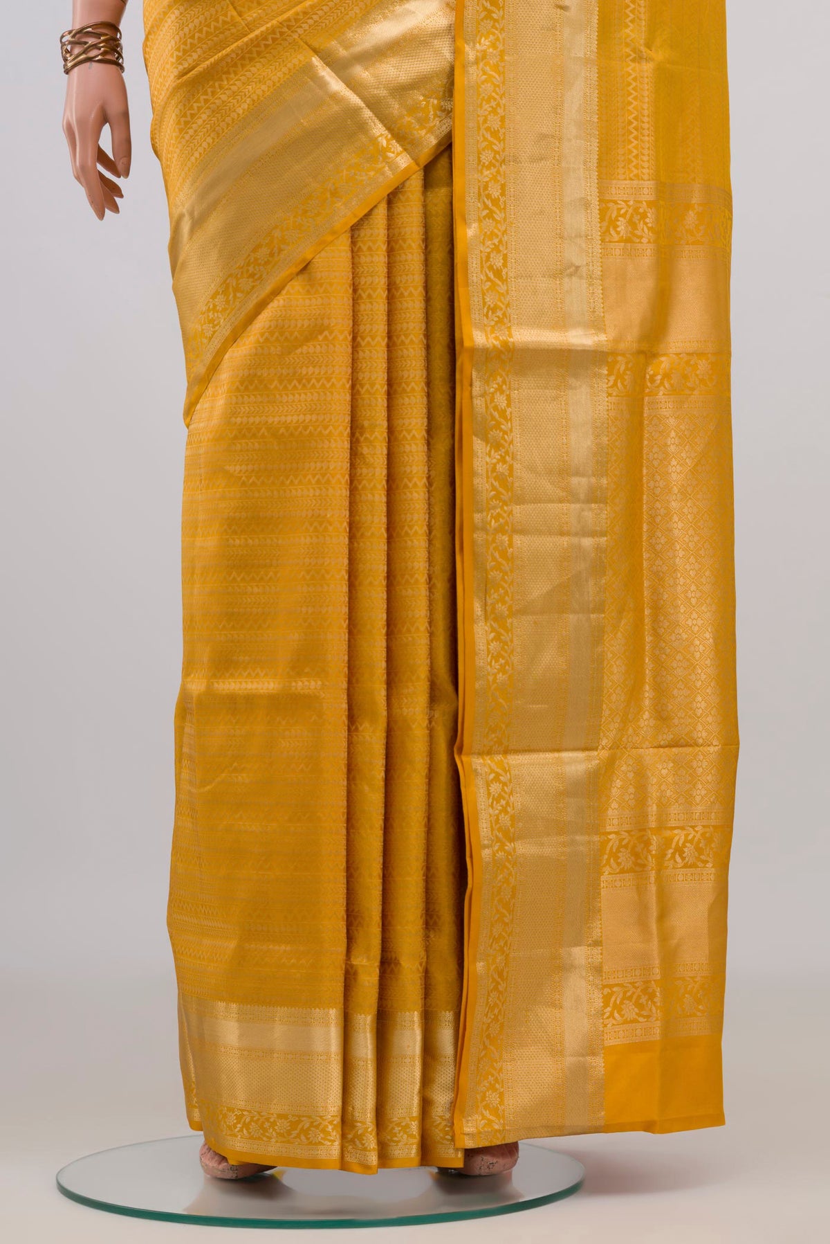 Pleats and pallu of Pure Silk Yellow Soft Saree with Zari Brocade on the body and Zari Border. 