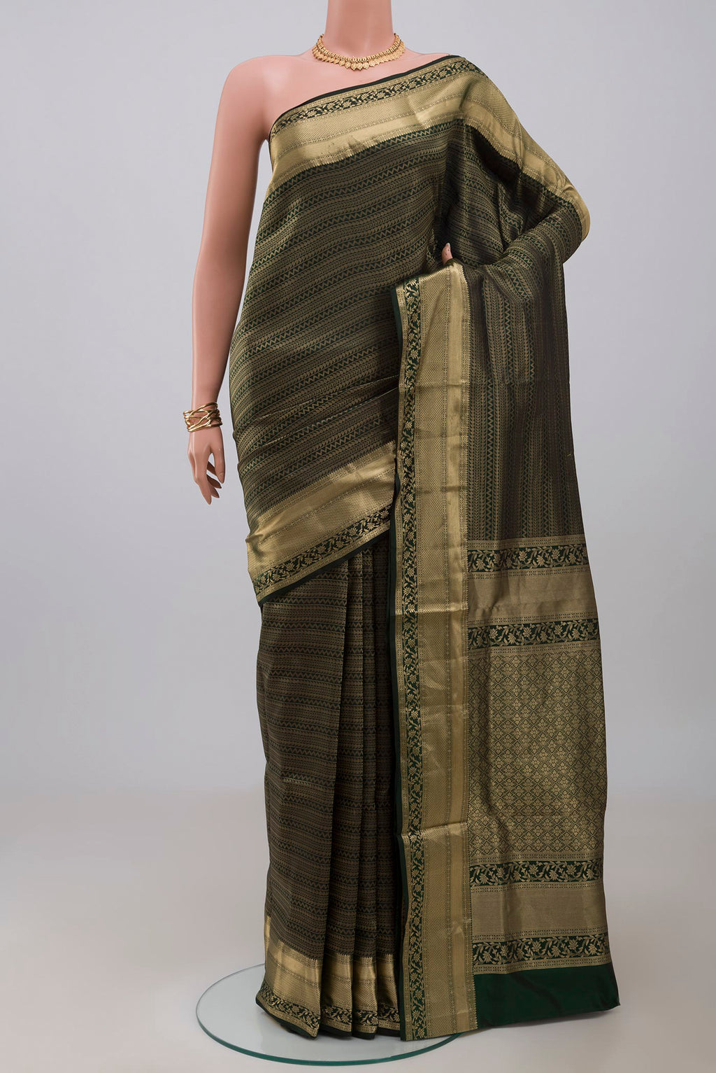 Green Soft Silk Saree with Zari Brocade on the body and Zari Border.  displayed on a mannequin