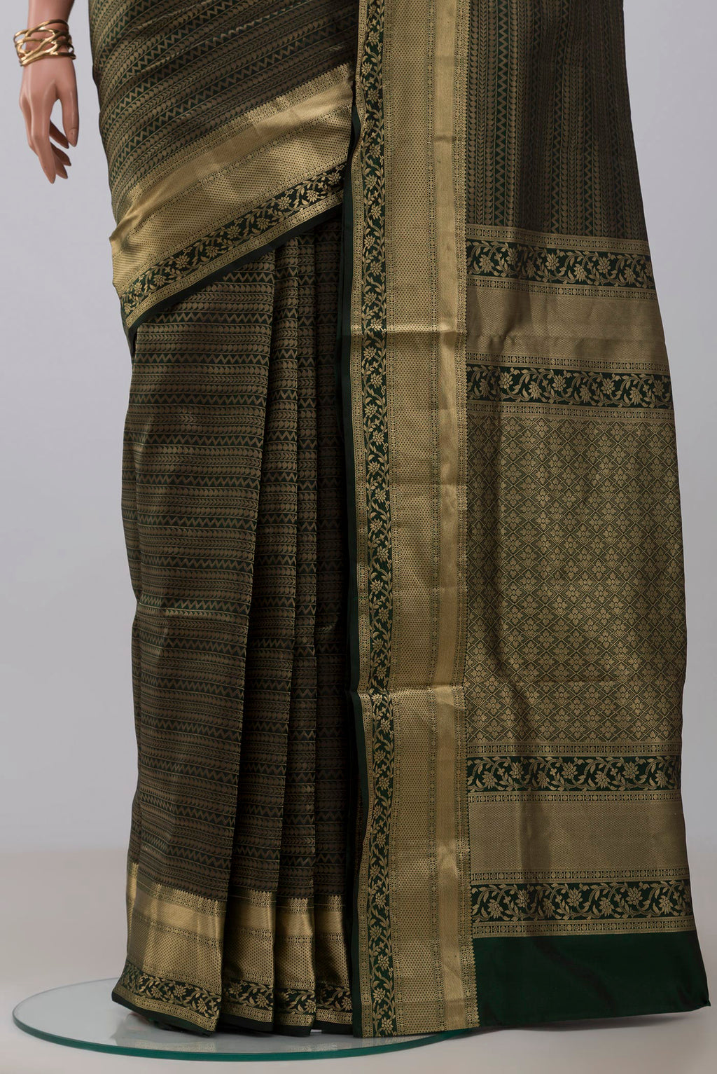 Pleats and pallu of Green Soft Silk Saree with Zari Brocade on the body and Zari Border. 