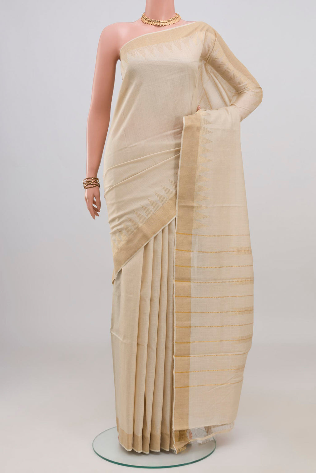 Cream Tussar Silk Saree with Plain Body and Thin Zari Line.  displayed on a mannequin