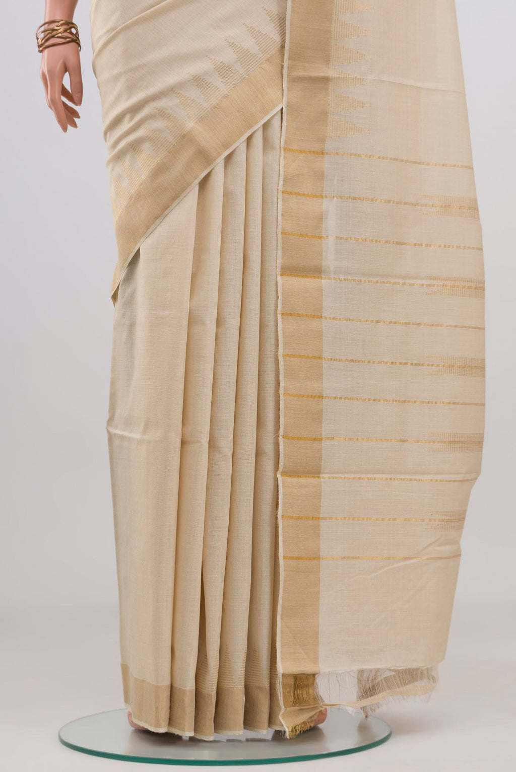 Pleats and pallu of Cream Tussar Silk Saree with Plain Body and Thin Zari Line. 