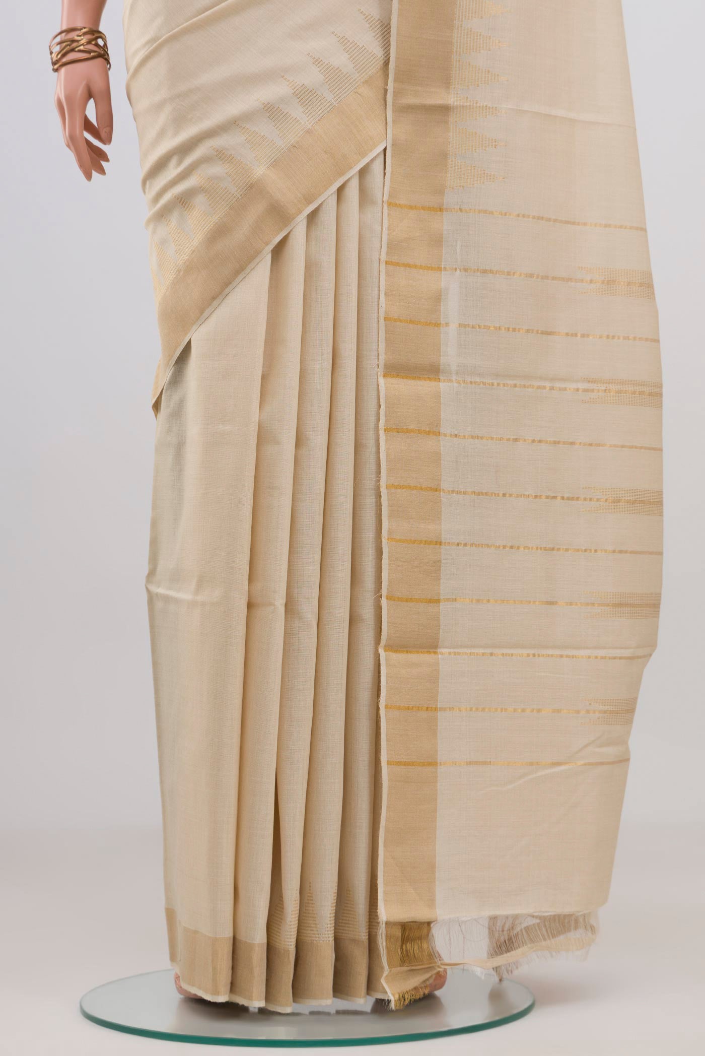 Pleats and pallu of Cream Tussar Silk Saree with Plain Body and Thin Zari Line. 