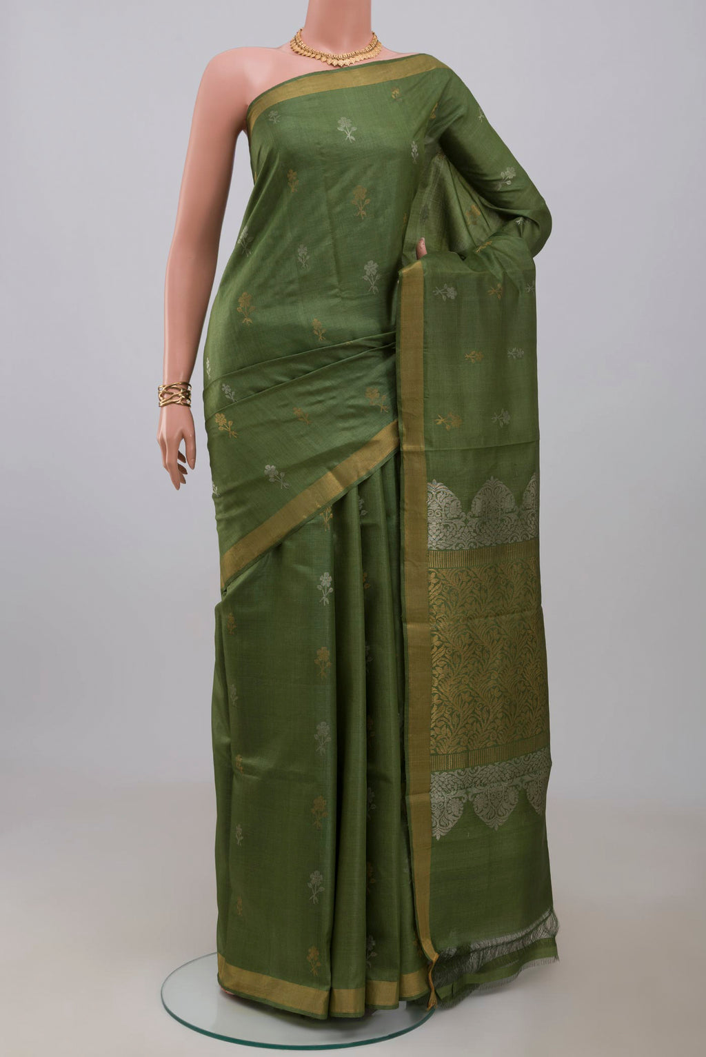 Sage Green Tussar Silk Saree with Zari Butta on the body and Zari Border.  displayed on a mannequin