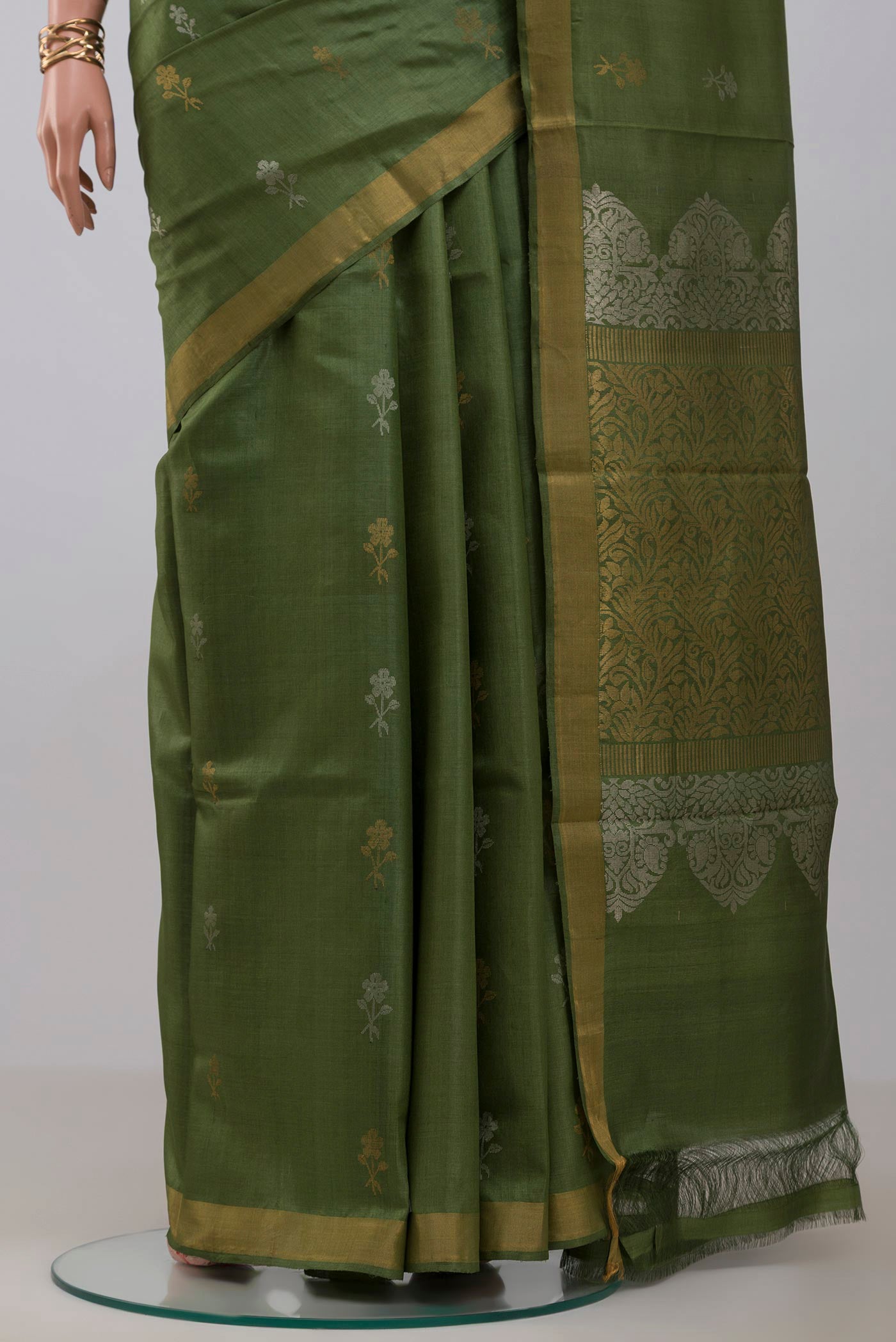 Pleats and pallu of Sage Green Tussar Silk Saree with Zari Butta on the body and Zari Border. 