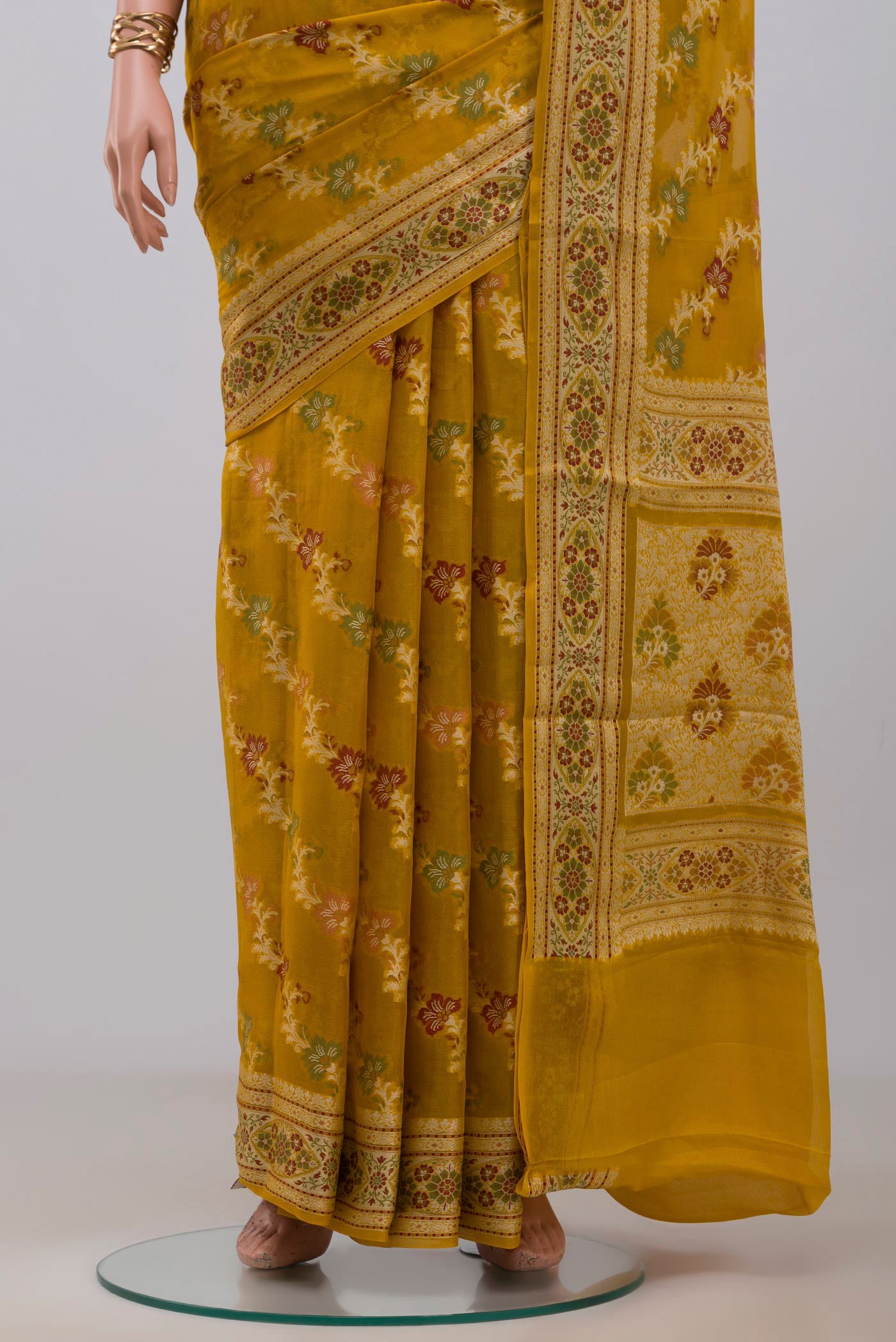 Pleats and pallu of Mustard Banarasi Georgette Saree with Thread Brocade on the body and Thread Border. 