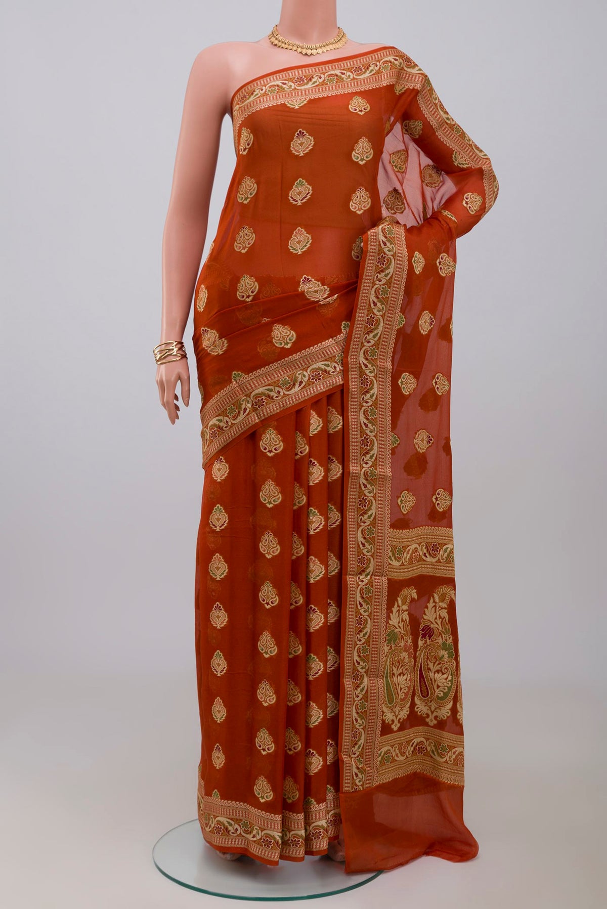 Rust Georgette Saree with Fancy on the body and Fancy Border.  displayed on a mannequin