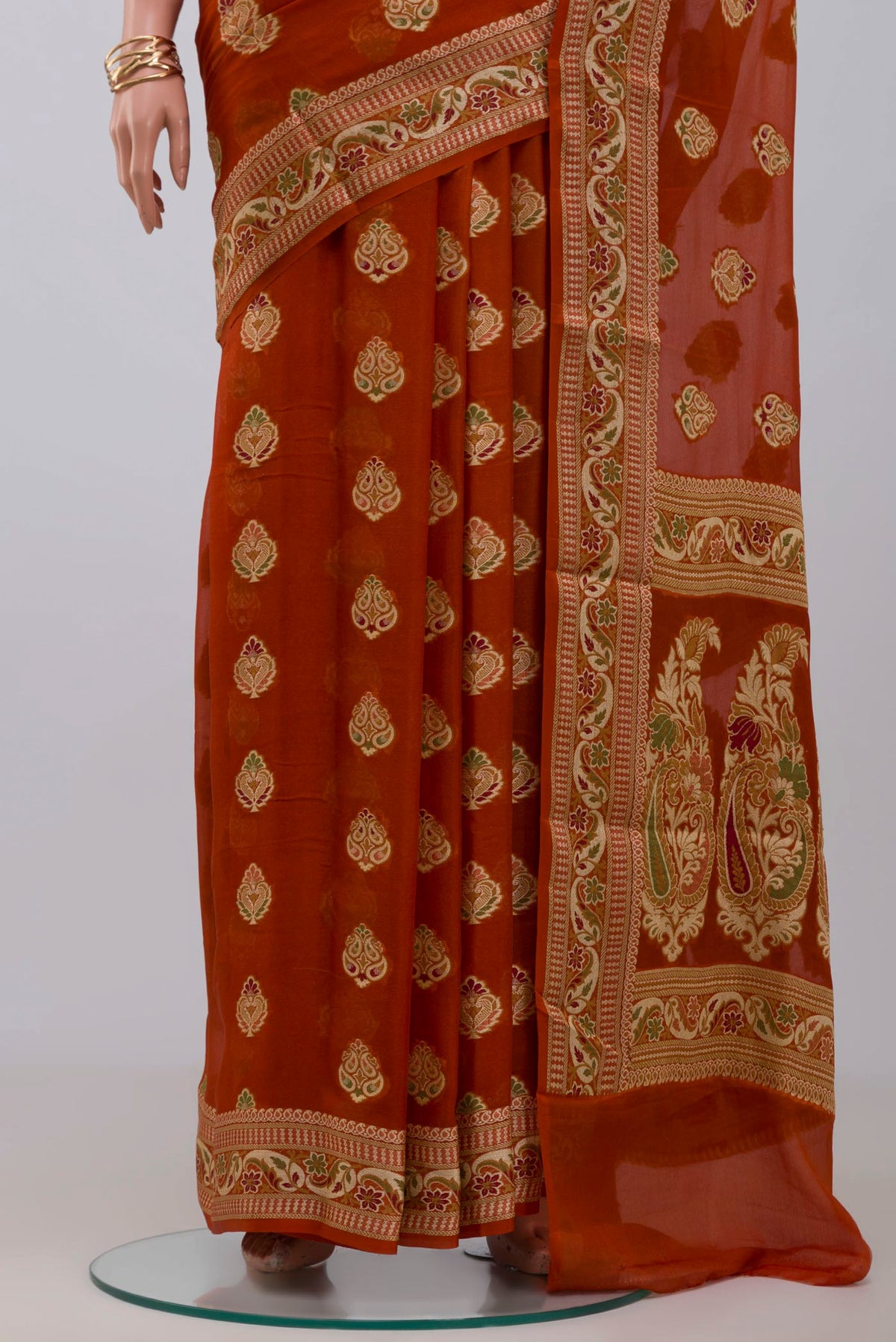 Pleats and pallu of Rust Georgette Saree with Fancy on the body and Fancy Border. 