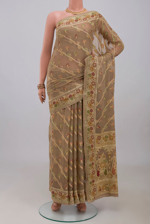Beige Banarasi Georgette Saree with Thread Butta on the body and Thread Border.  displayed on a mannequin