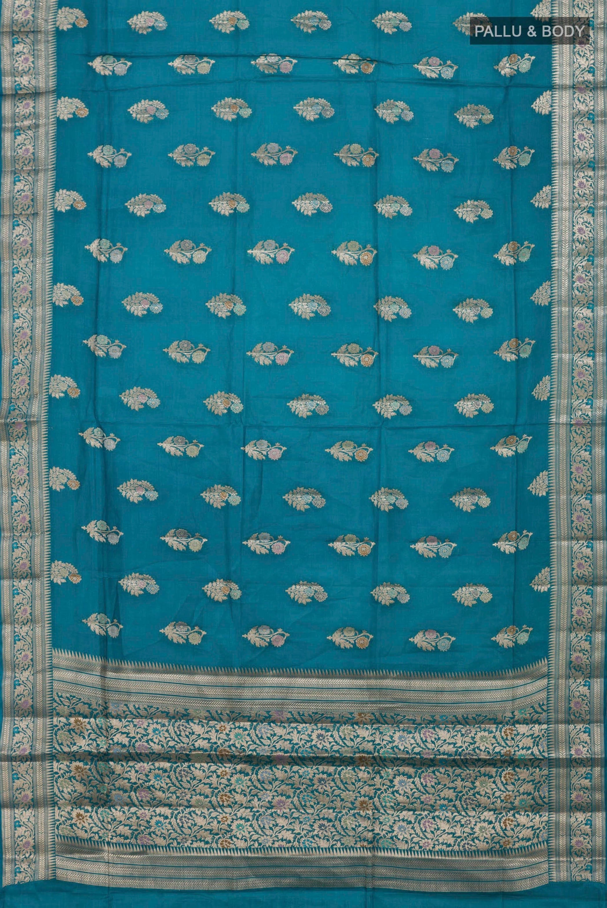 Flat view of Blue Tussar Silk Saree with Zari Butta on the body and Zari Border. 