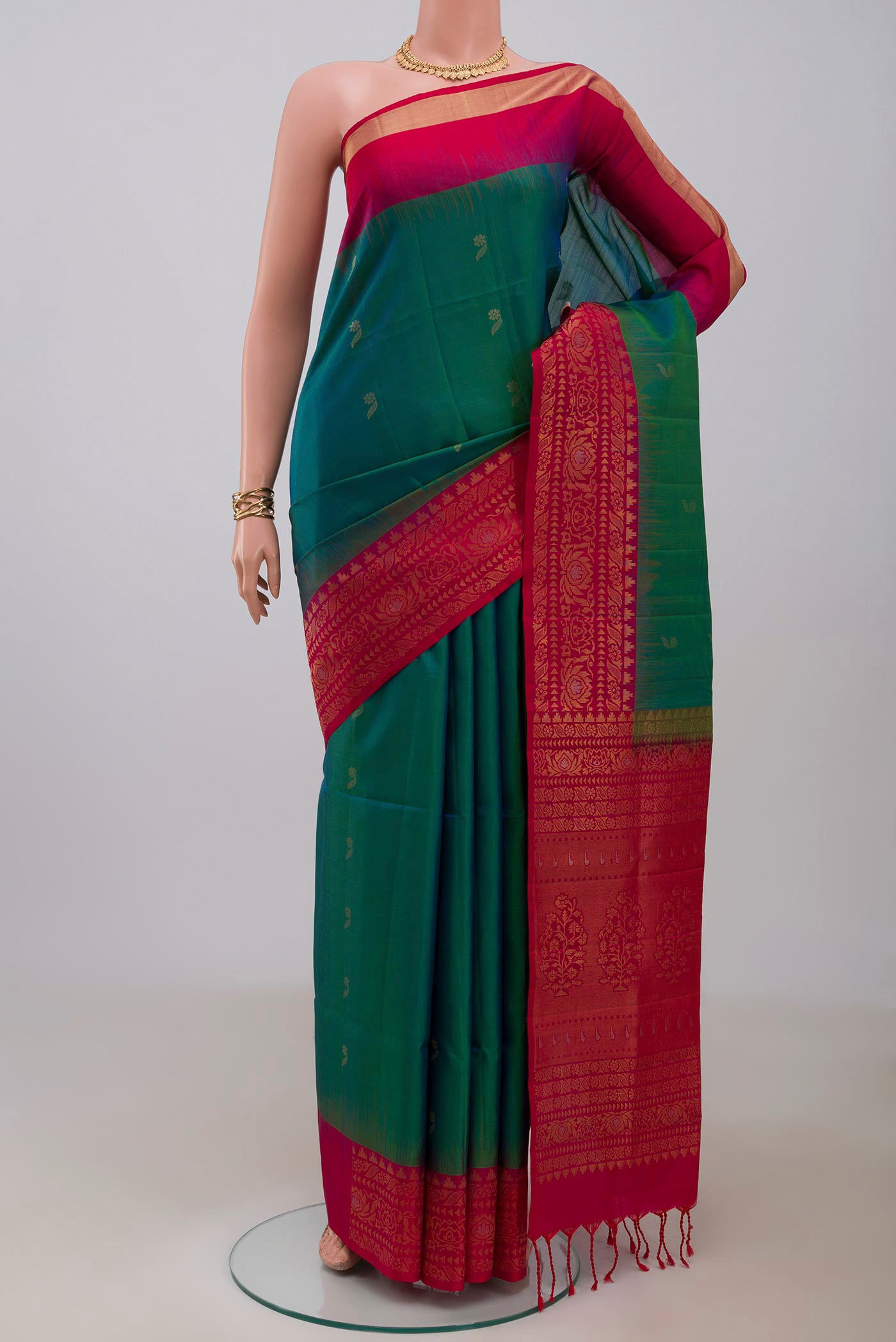 Peacock Blue Soft Silk Saree with Zari Butta on the body and Fancy Border.  displayed on a mannequin