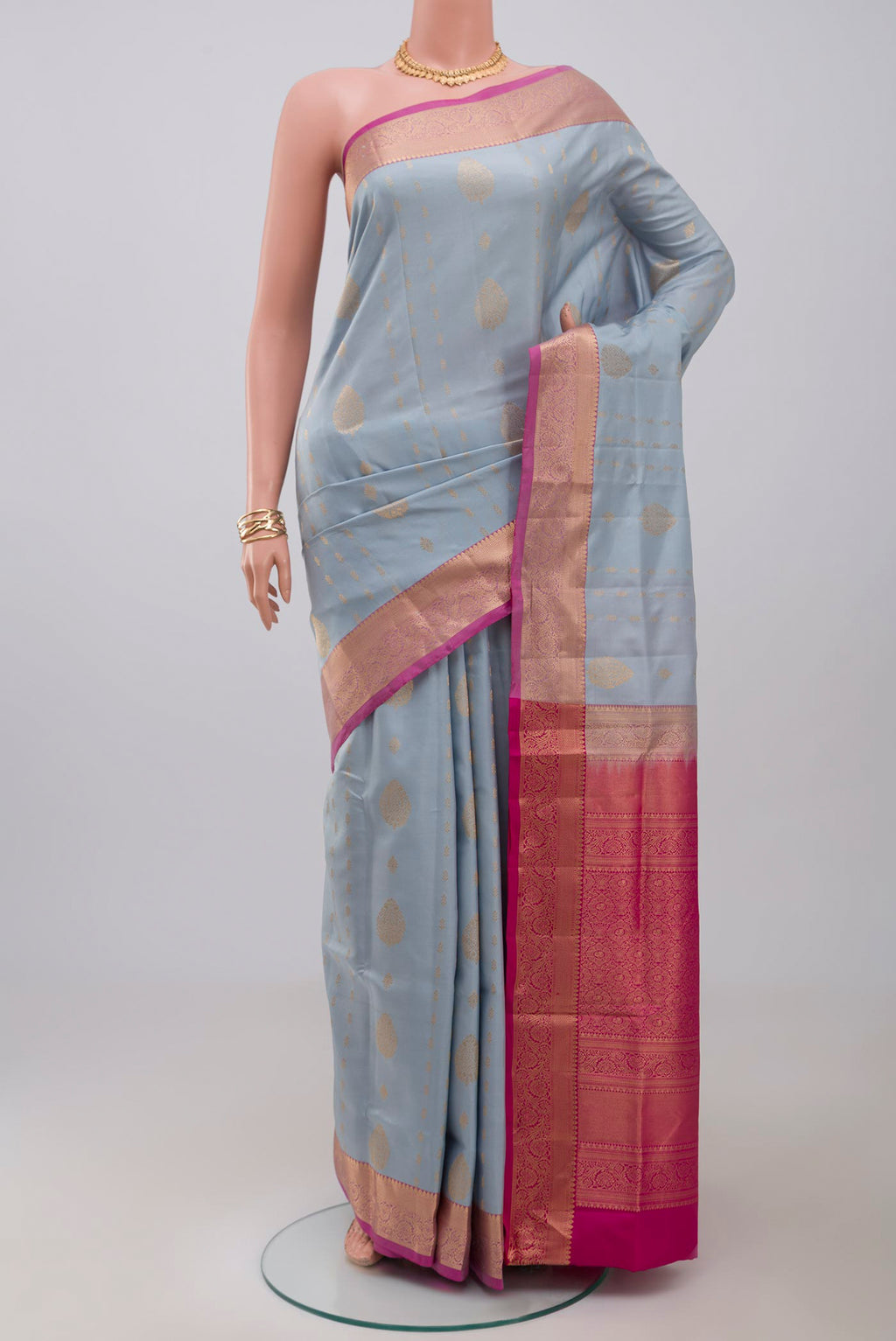 Light Blue Soft Silk Saree with Zari Butta on the body and Zari Border.  displayed on a mannequin